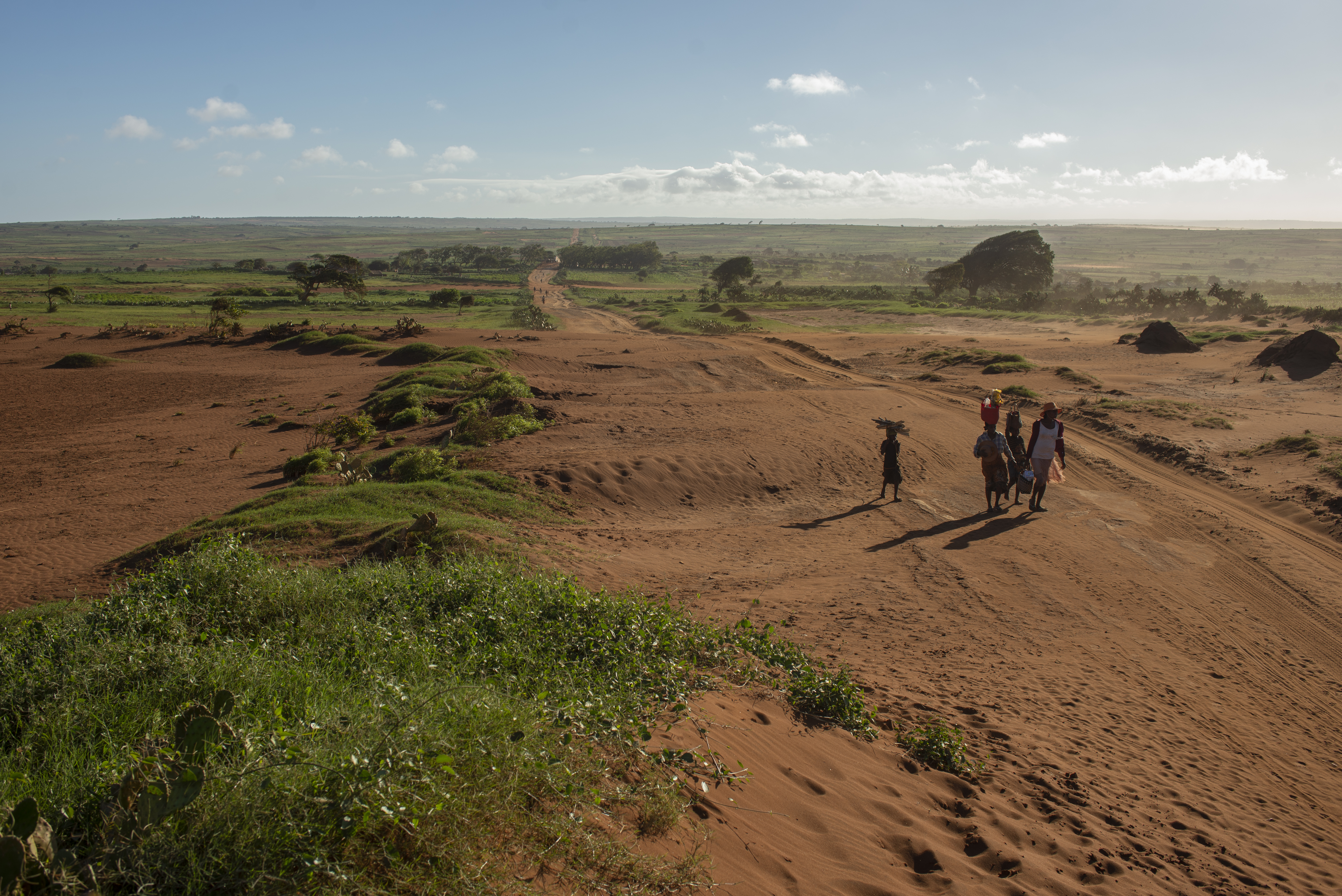 Residents walk along a road leading to the provincial capital of Androy Province. Observers say decades of under development have contributed to current hunger crisis. [Joseph Stepansky/Al Jazeera]
