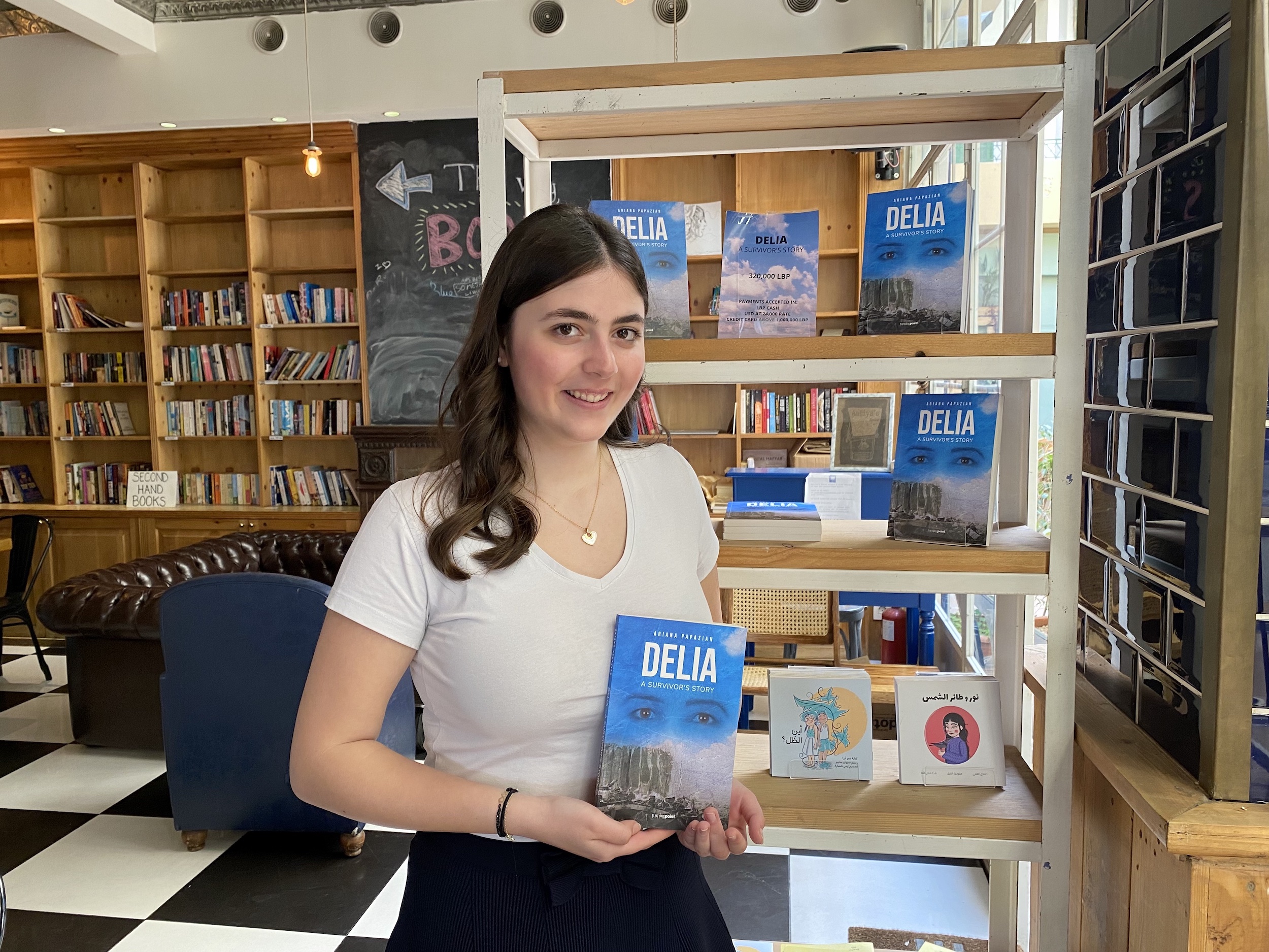 Ariana Papazian holds her memoir Delia A Survivor's Story