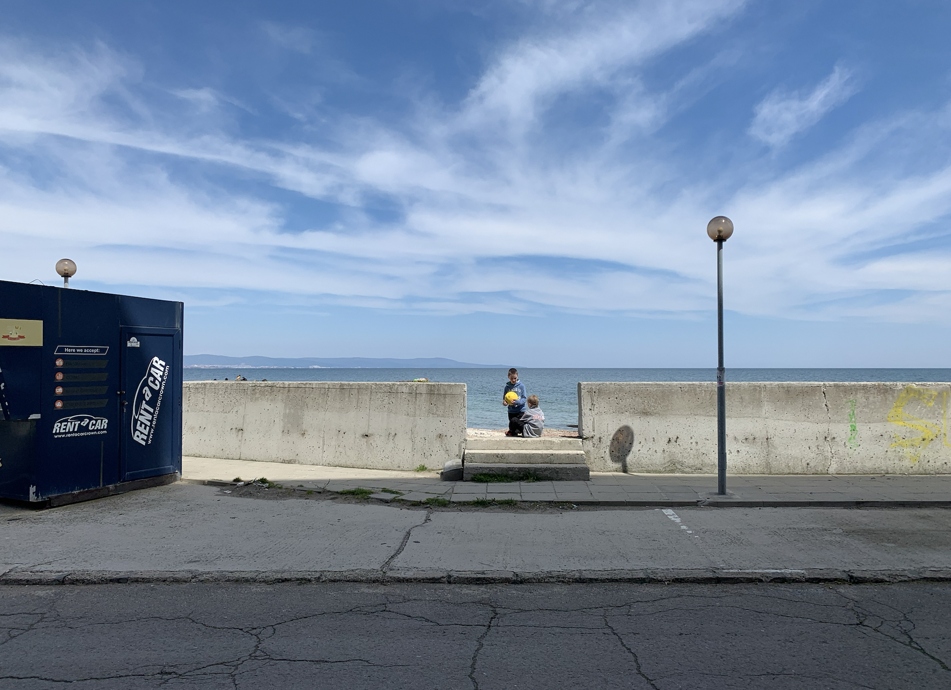 Two Ukrainian boys play with a ball on the beach in Pomorie [Antoaneta Roussi/Al Jazeera]