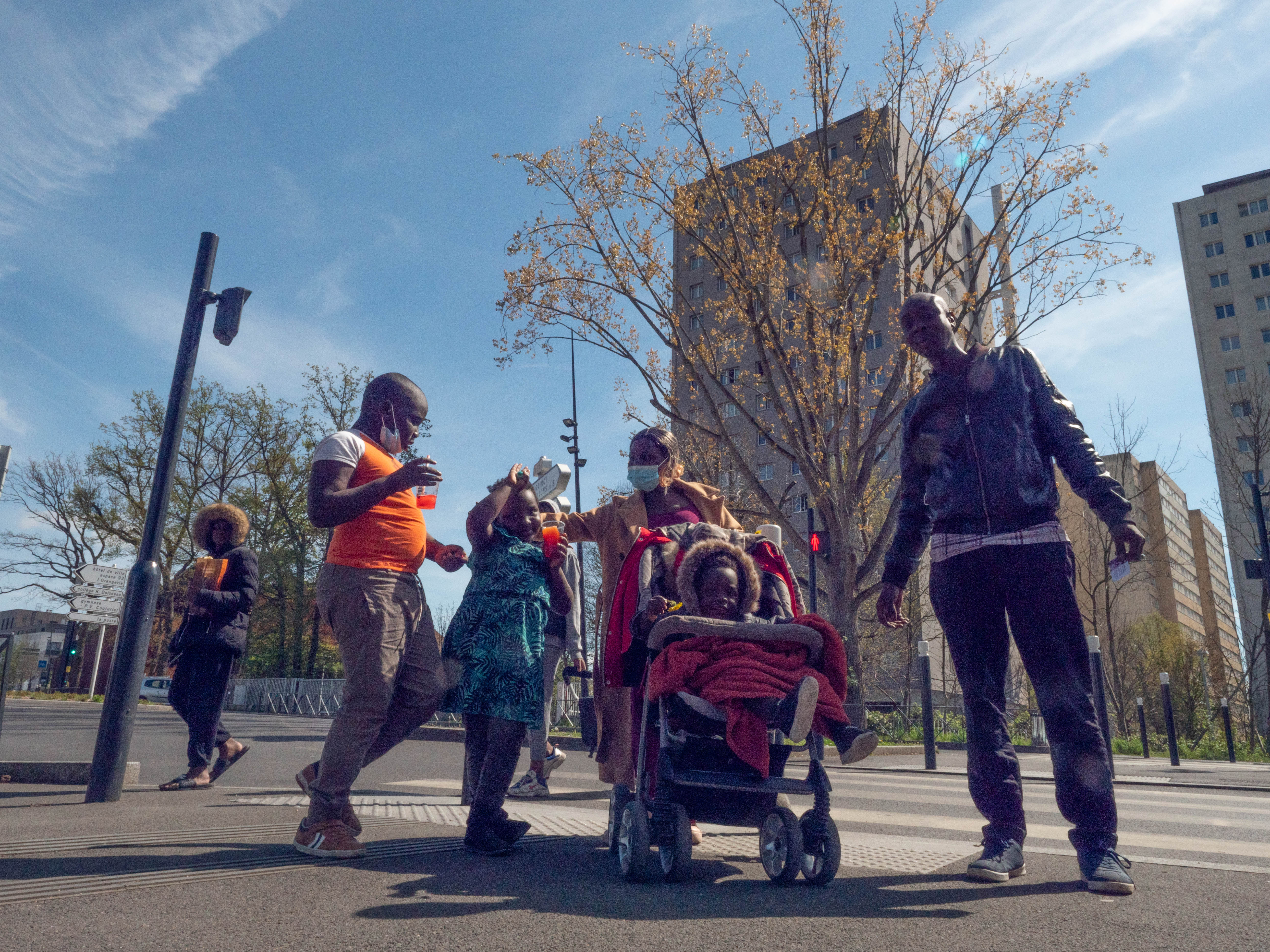 Maanty and Emmanuela Seck-Pavelus with three of their children, Adel 8, Enelya 5 and Fresnel 2 - they live on the 13th floor of the high-rise in background