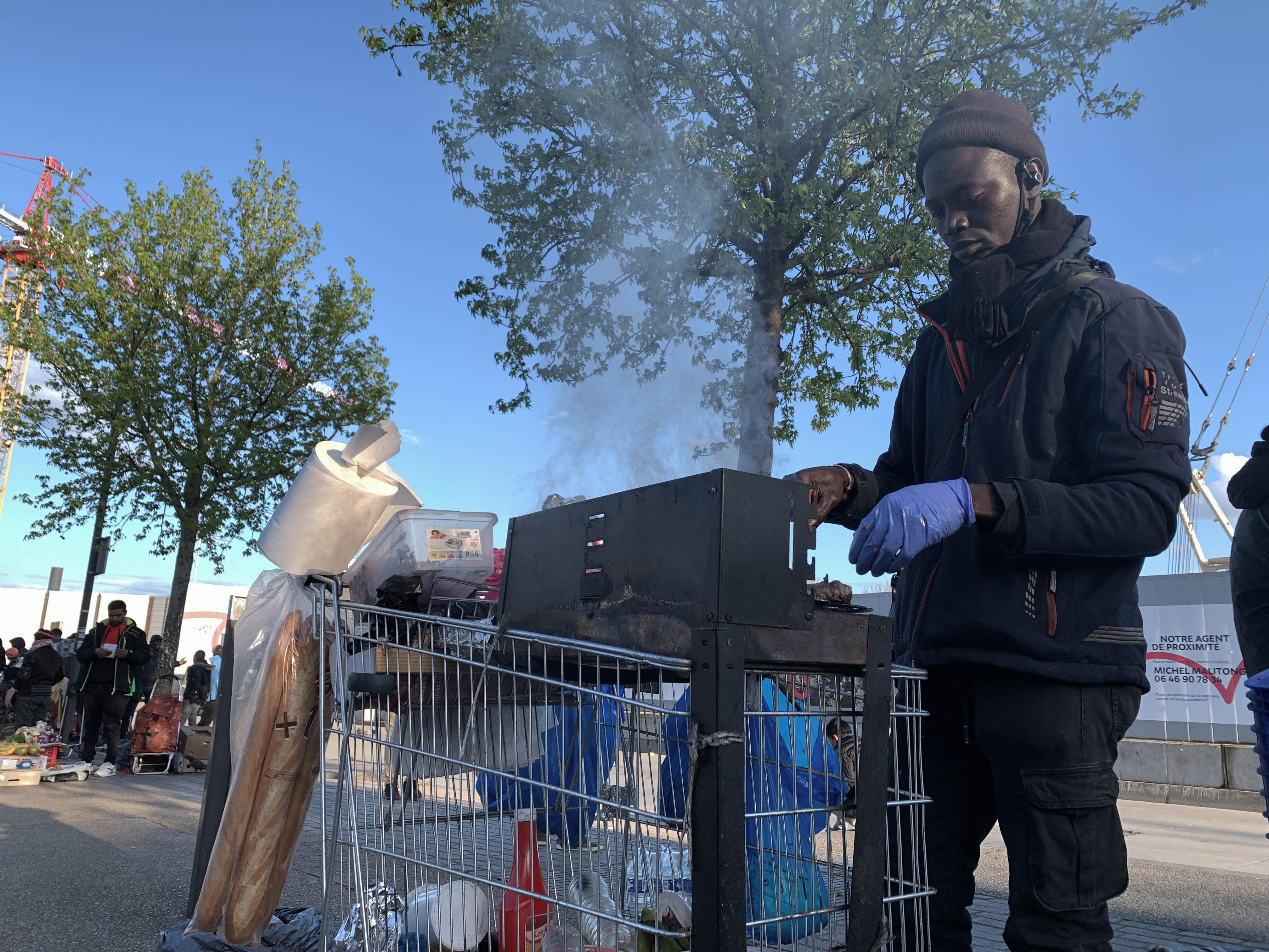 Vendors cook meat on supermarket trolleys outside Sevran Beaudottes metro station