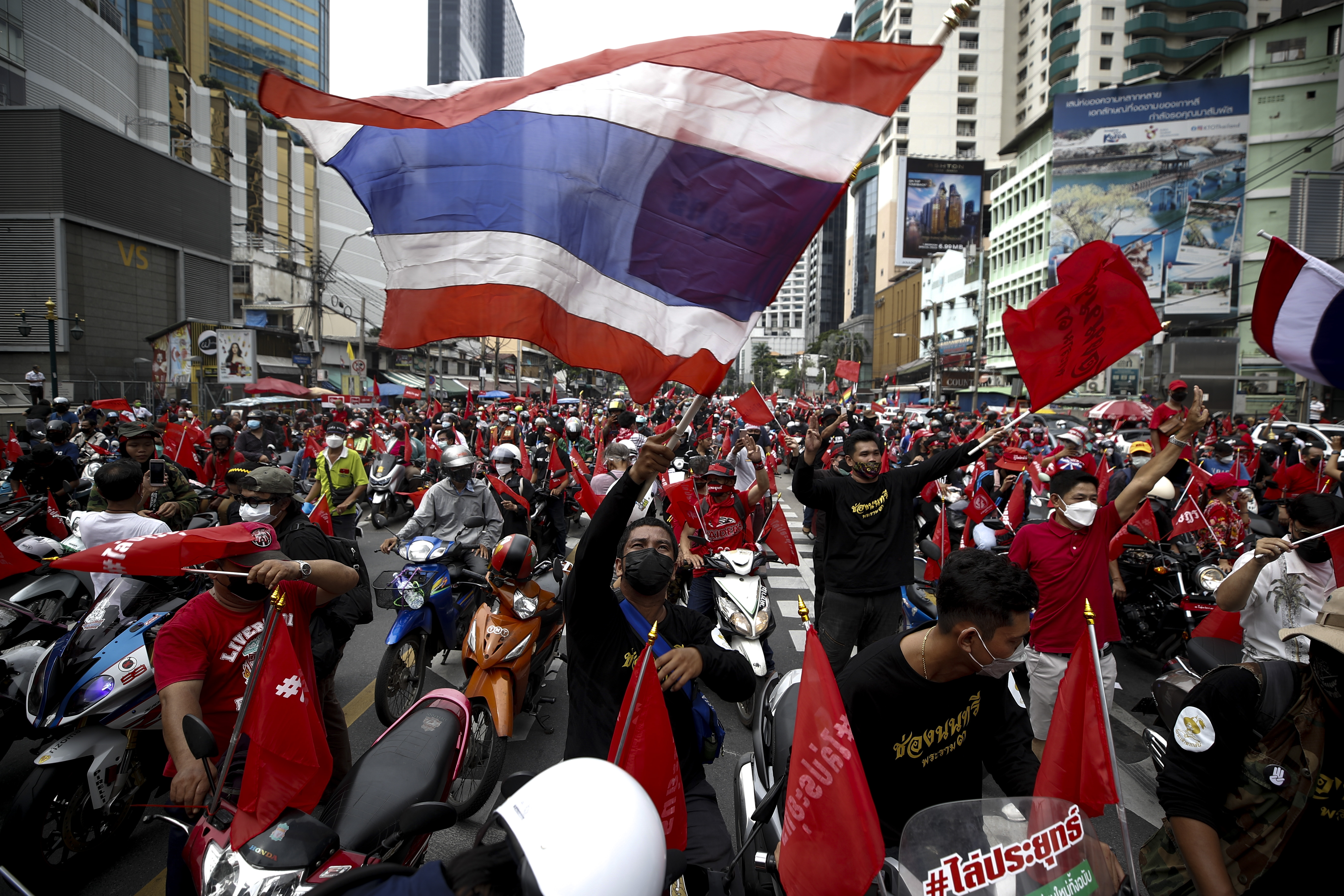 nti-government protesters flash the three finger salute and wave Thailand's flag at a rally filing a street i Bangkok last September 