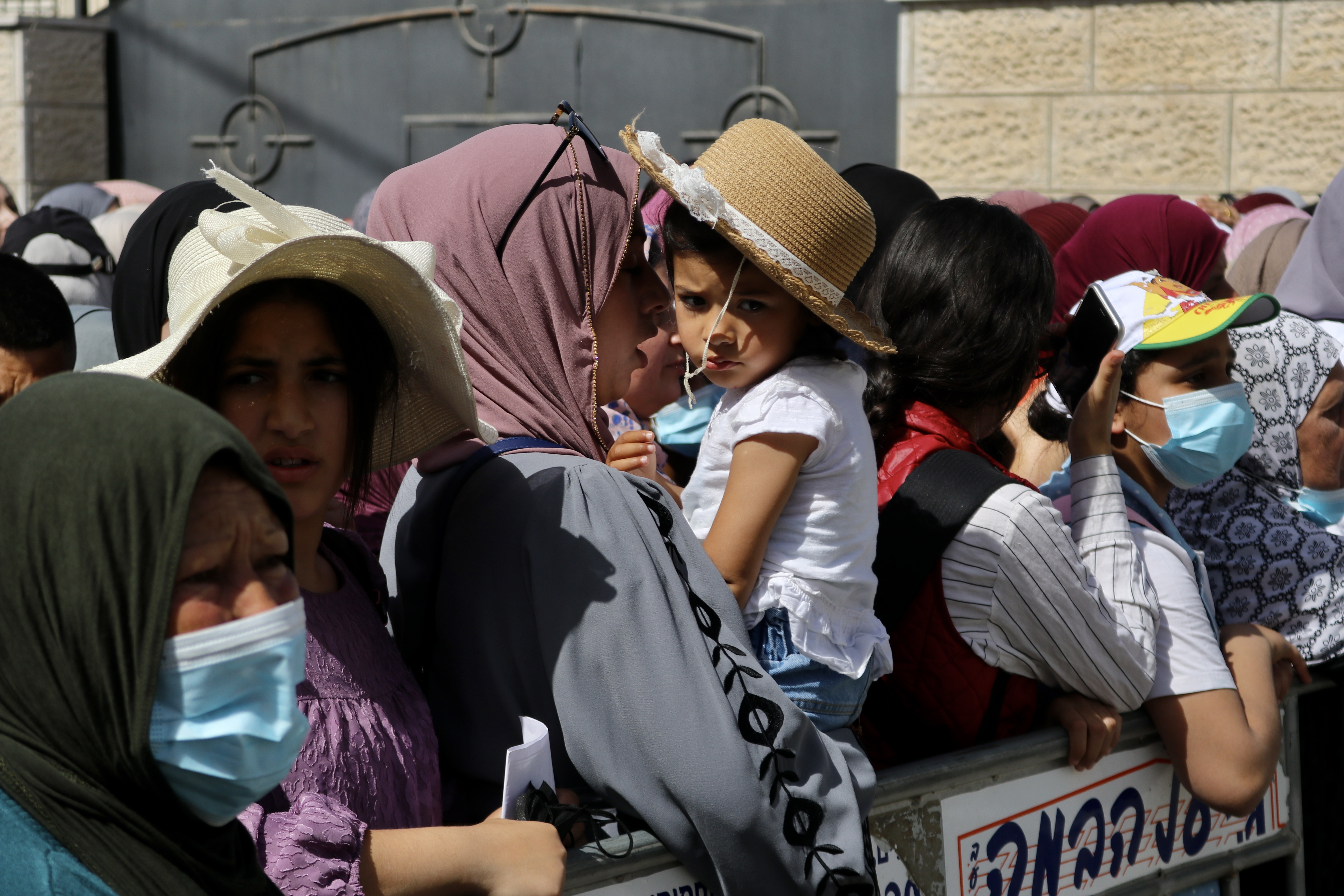 Palestinians wait at a checkpoint in Bethlehem