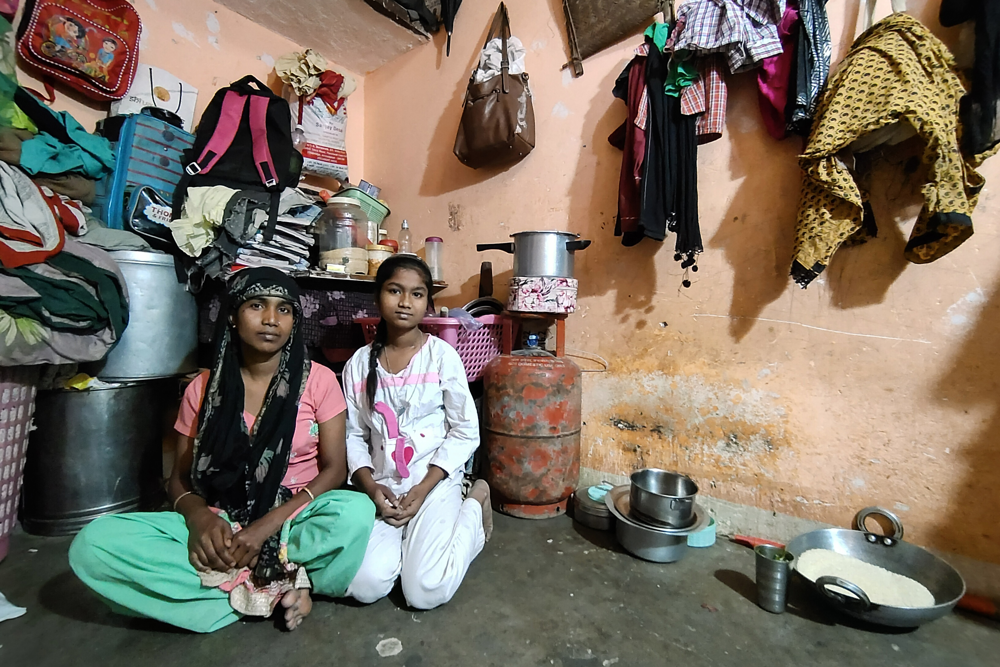 Kaushilya Devi, domestic help, with her daughter Rakhi in their home in Delhi, India
