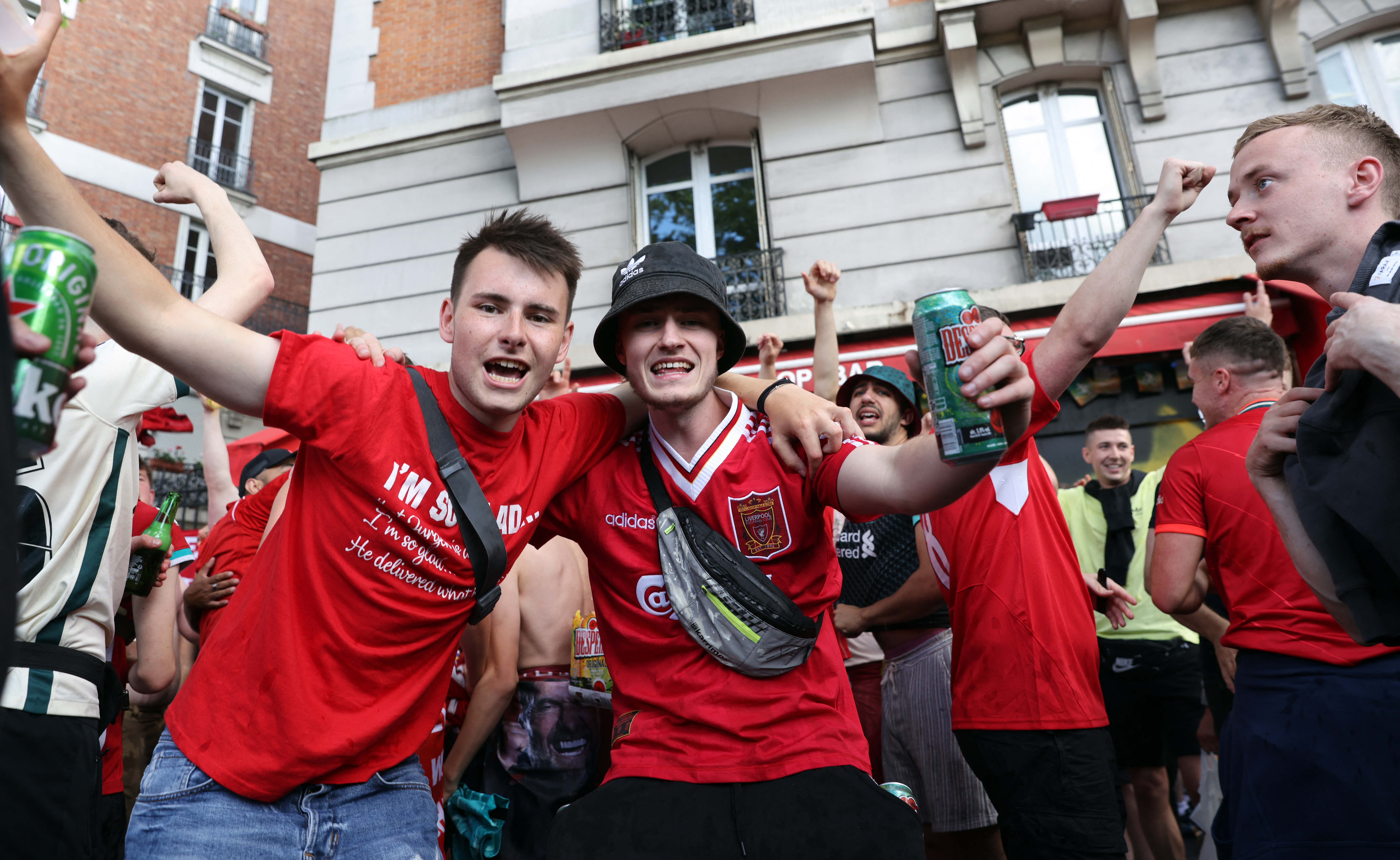 Liverpool FC's supporters dance and drink near a bar in Paris