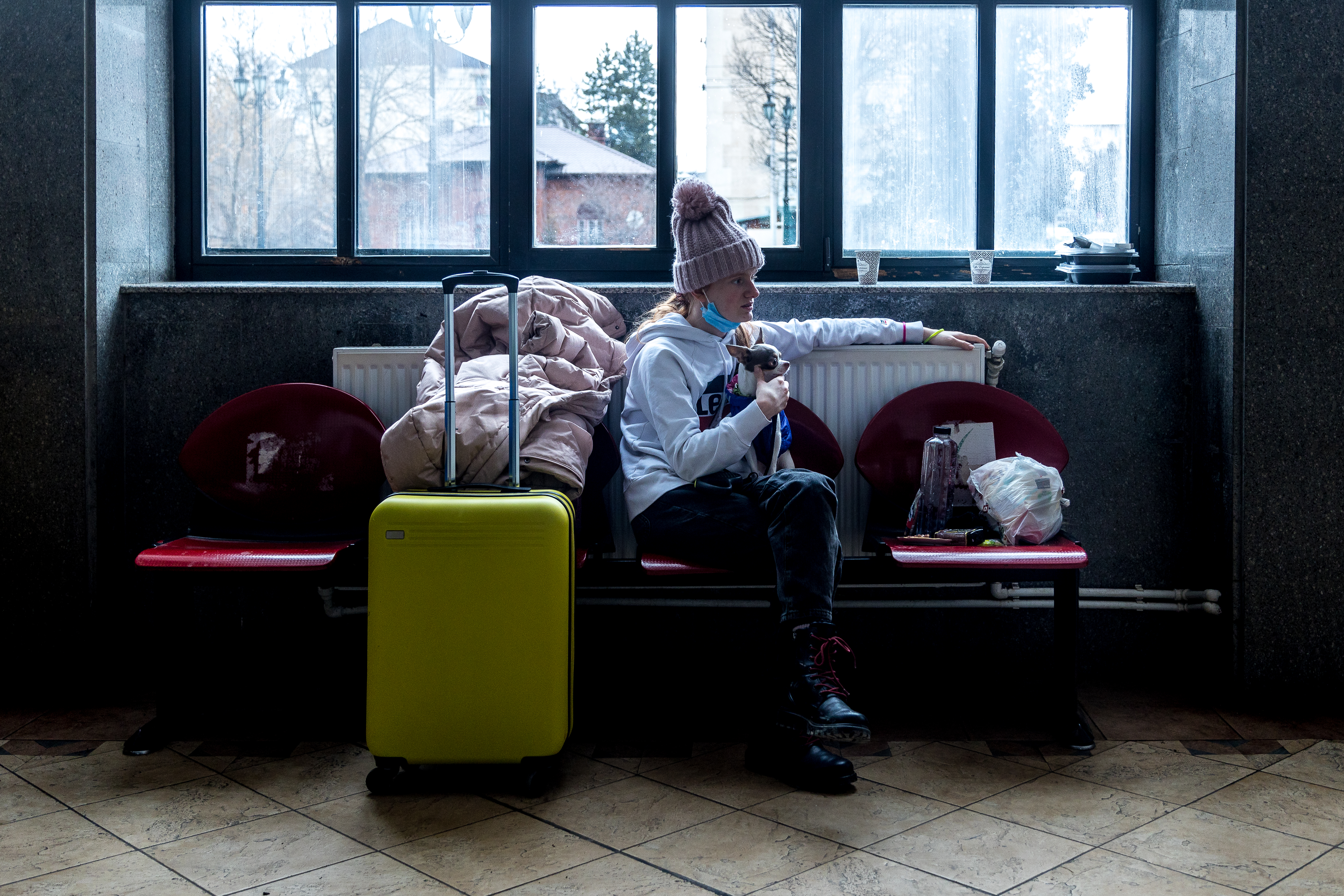 A woman sits in a train station