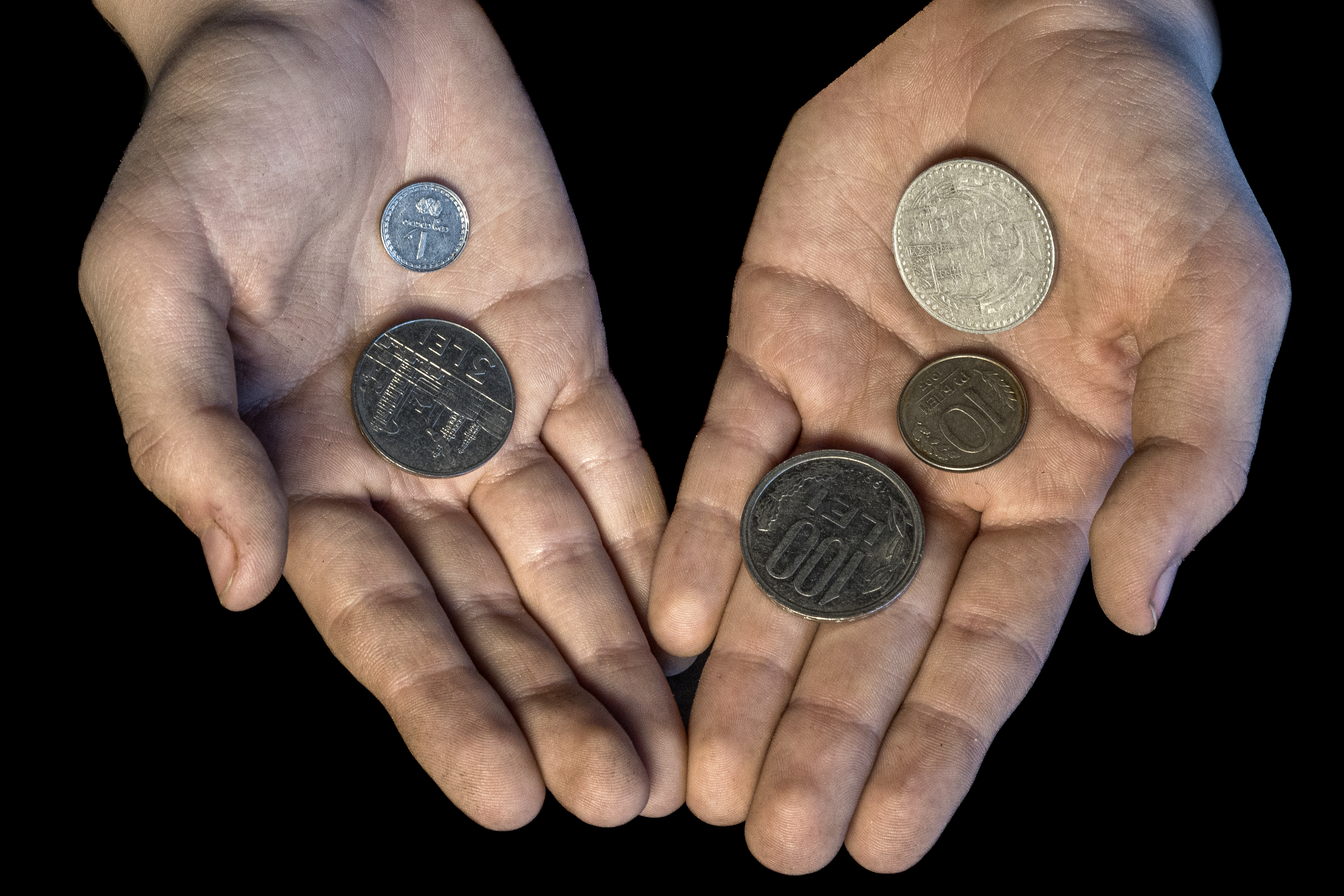 Hands holding coins