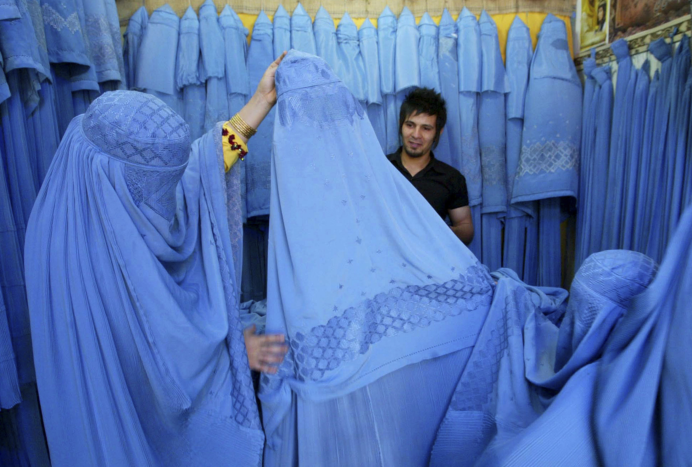 An Afghan woman looks at merchandise at a burqa shop in Herat in western Afghanistan.