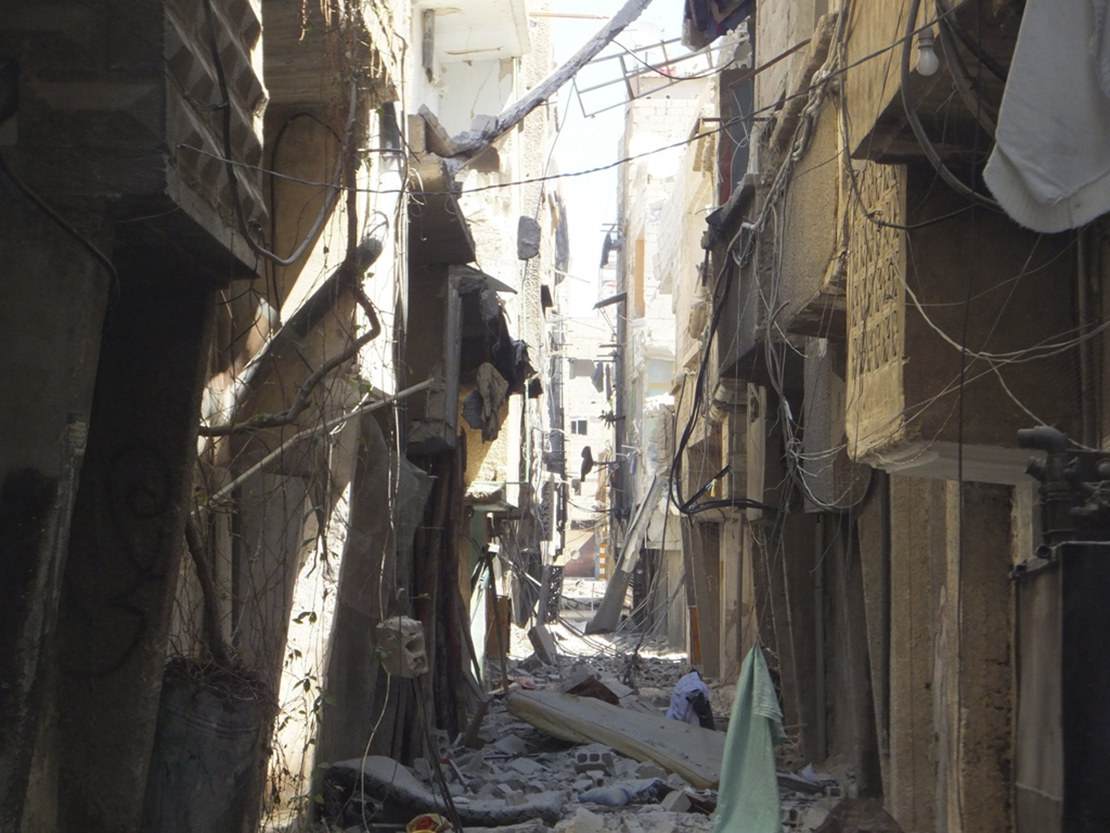 Damaged buildings are seen at al-Tadamon in Damascus in this handout photo provided by Shaam News Network September 7, 2012. REUTERS/Shaam News Network/Handout (SYRIA -