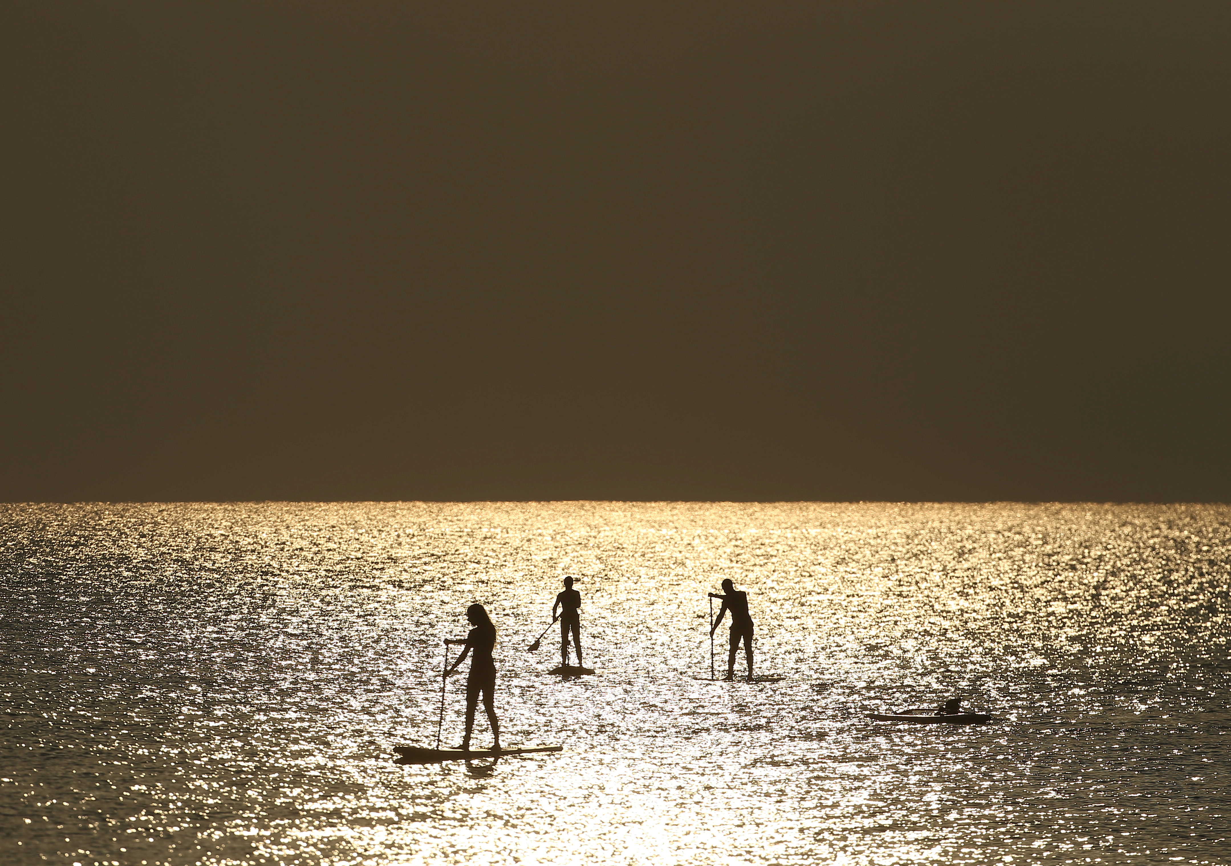 People paddle on stand-up boards in Cyprus