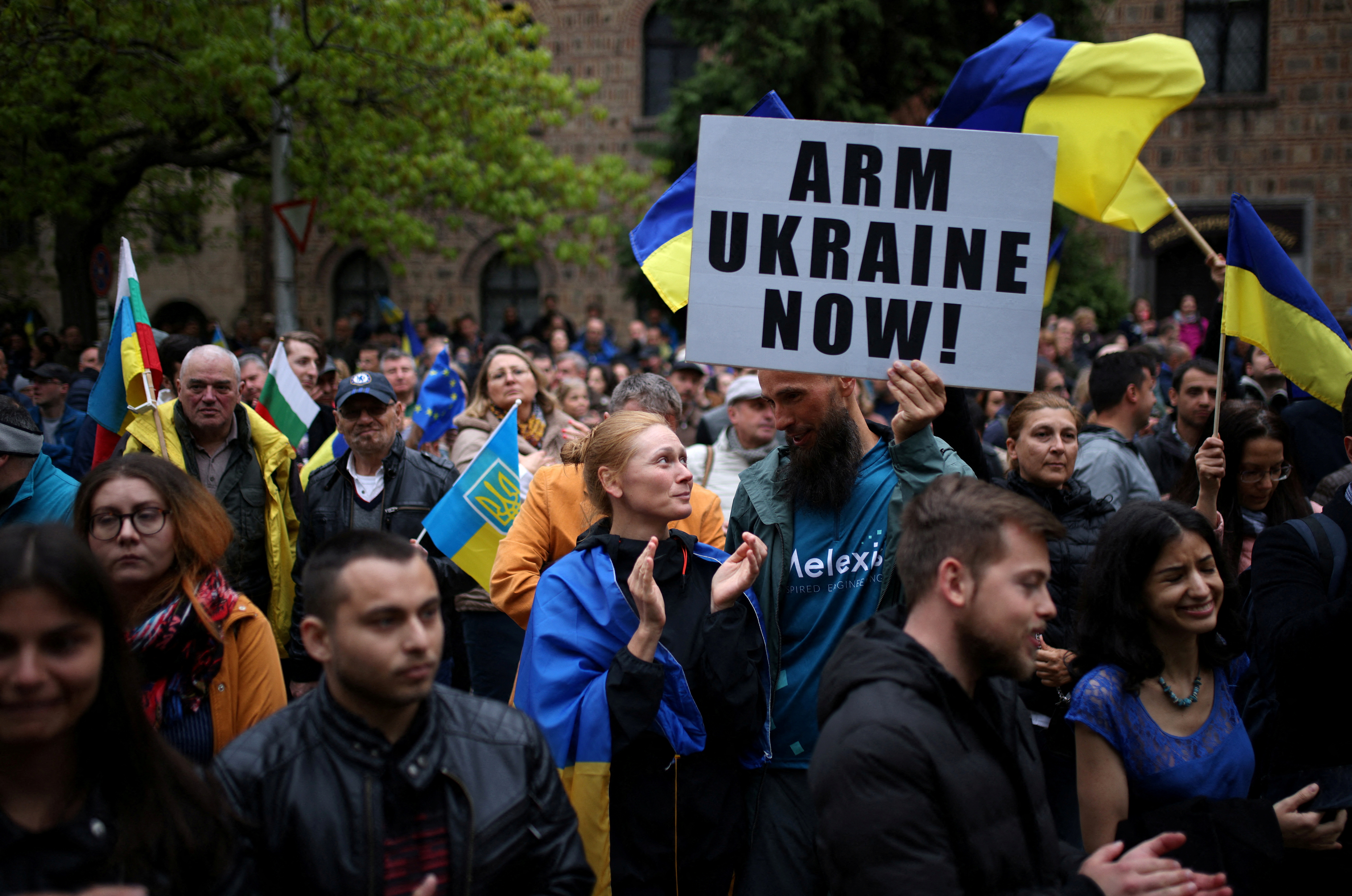 People take part in a demonstration urging the government to provide arms and ammunition aid to Ukraine