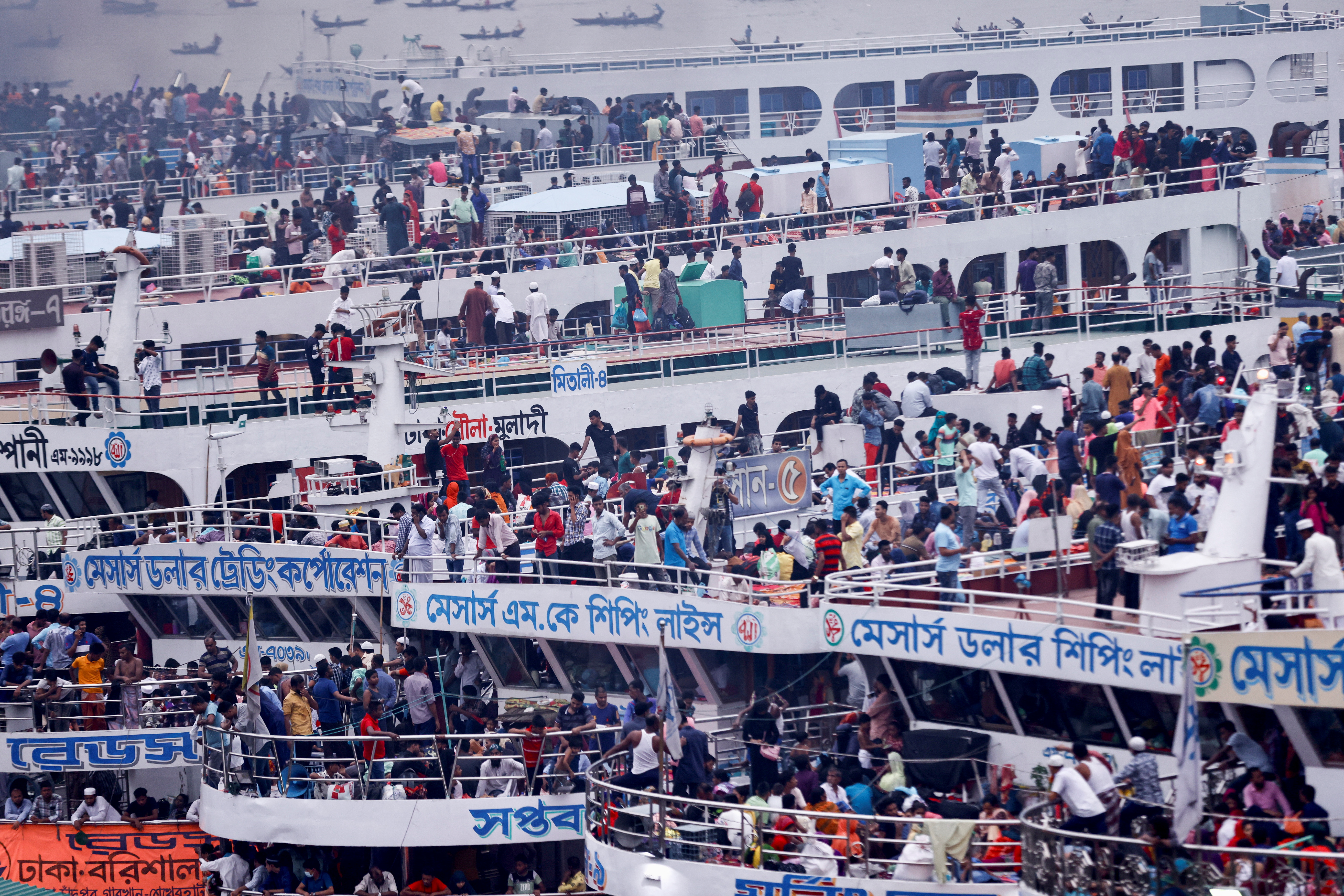 People sit onboard passenger ferries to travel home to celebrate Eid al-fitr, at the Sadarghat Launch Terminal, in Dhaka