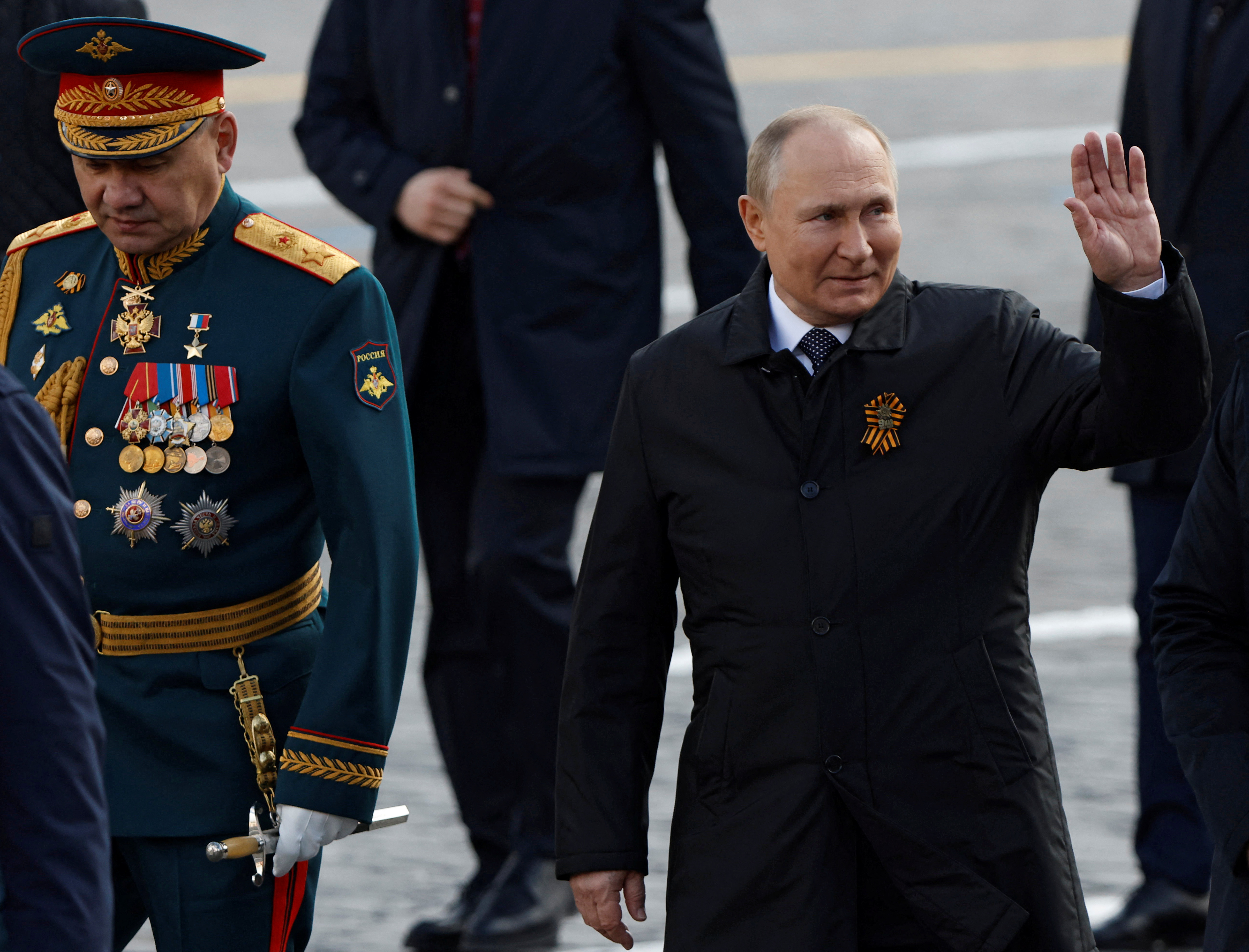 Russian President Vladimir Putin and Defence Minister Sergei Shoigu walk after a military parade on Victory Day