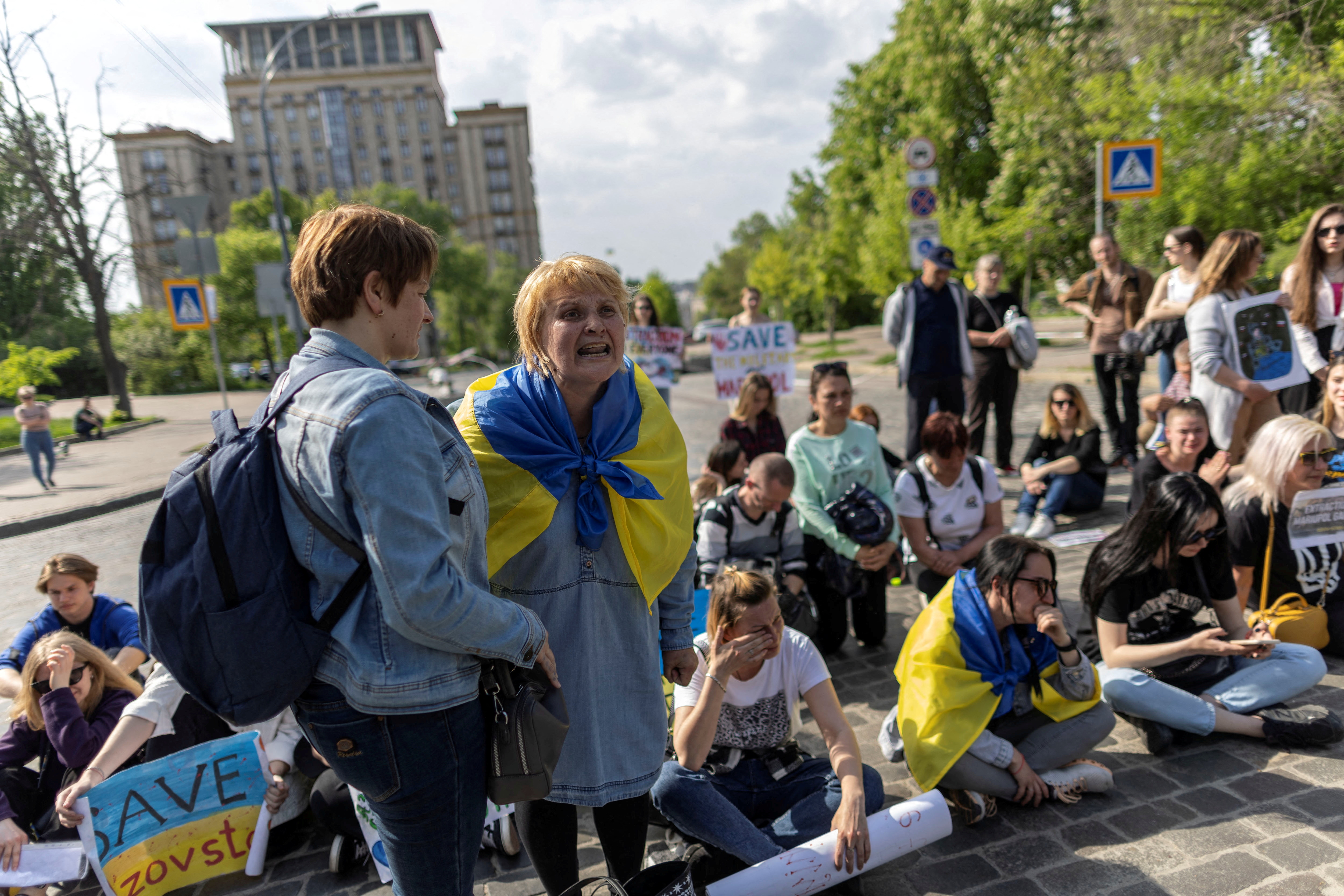 A woman reacts as relatives of Ukrainian service members who are besieged inside of the Azovstal Iron and Steel Works in Mariupol attend a protest to demand a rescue operation 