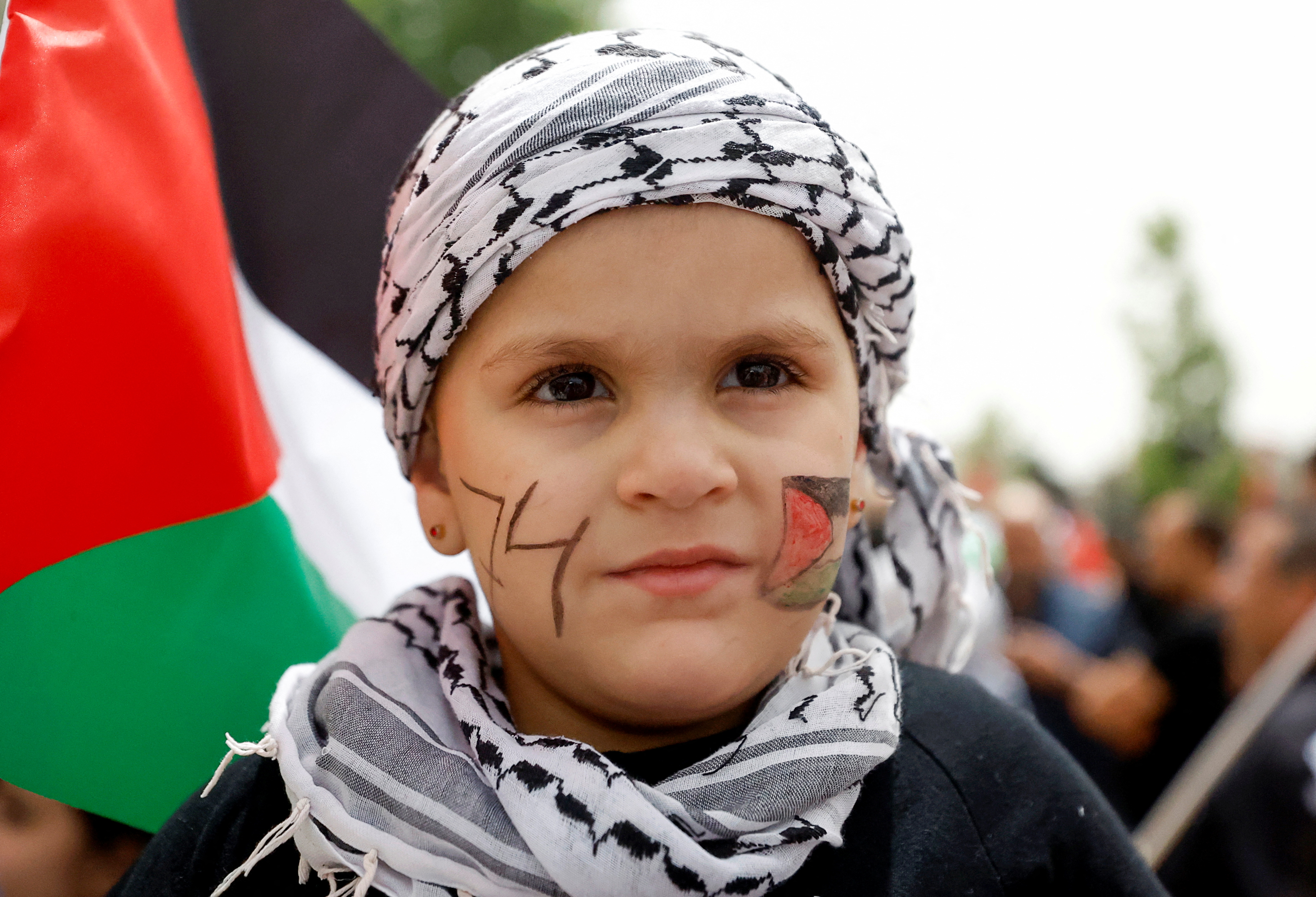 Palestinian wave national flags as they march in a rally marking the 74th anniversary of the "Nakba" or "catastrophe"