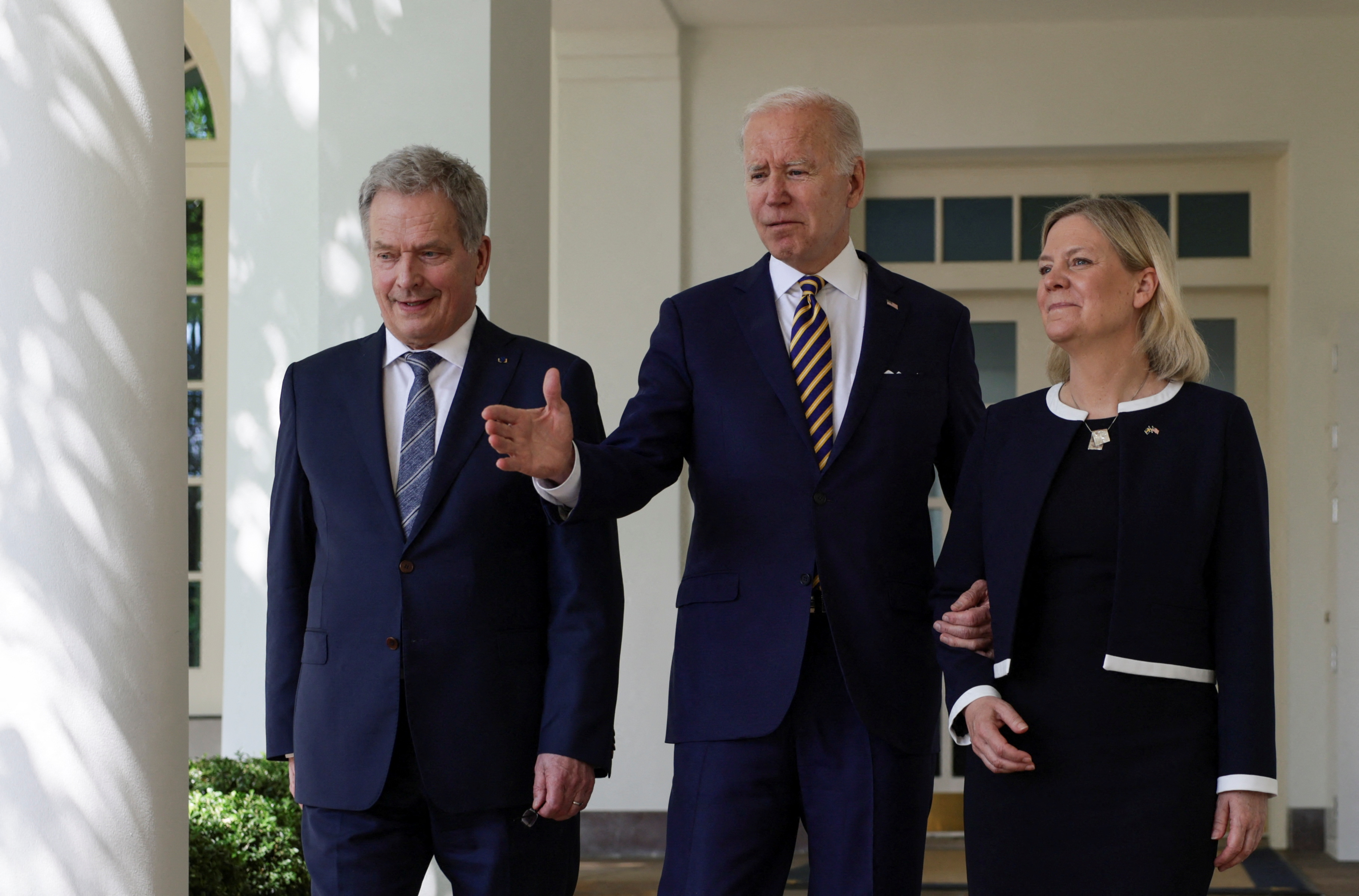 U.S. President Joe Biden walks with Sweden's Prime Minister Magdalena Andersson and Finland's President Sauli Niinisto