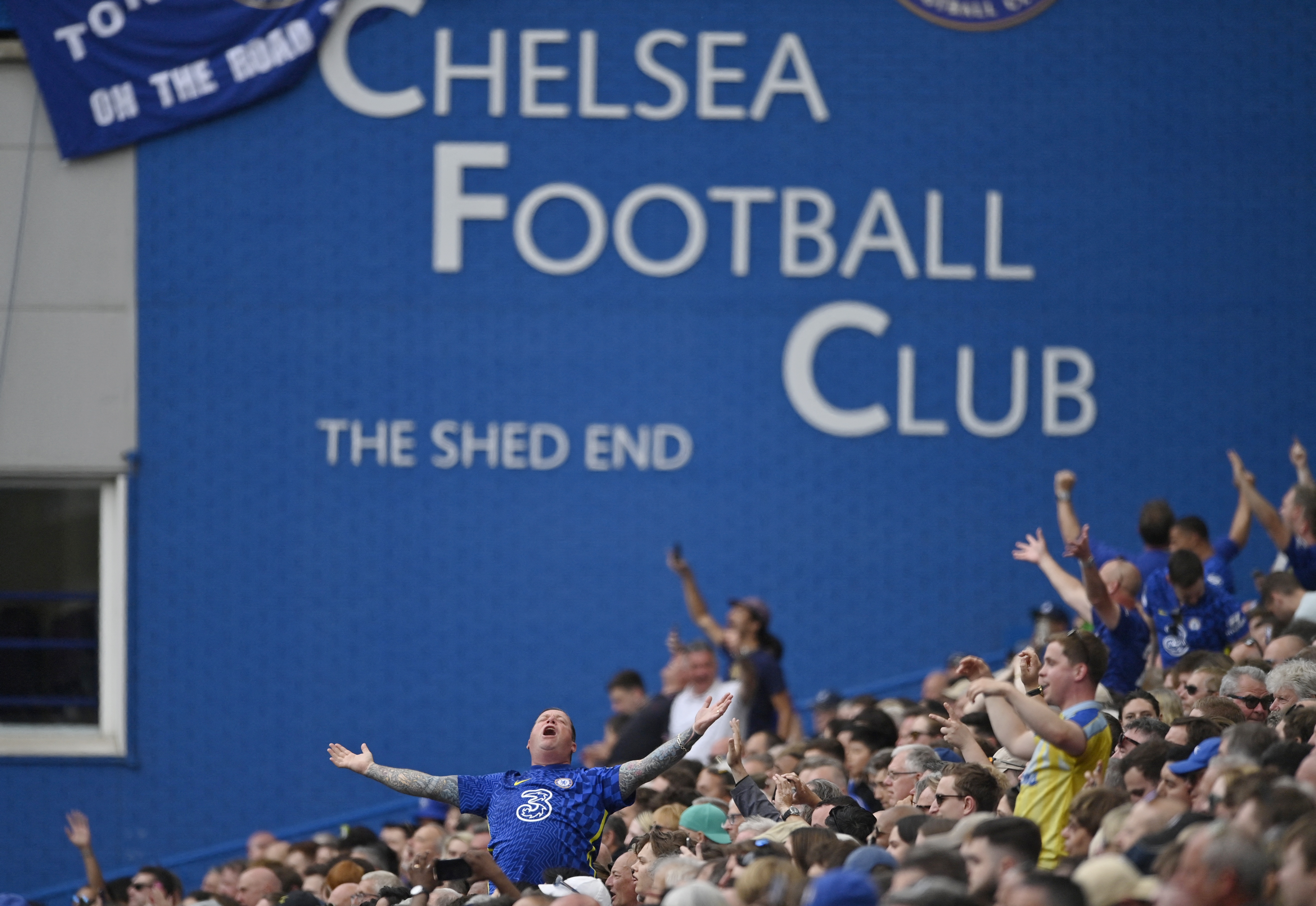 Background of Chelsea Football Club sign with fans inside the stadium during the match.