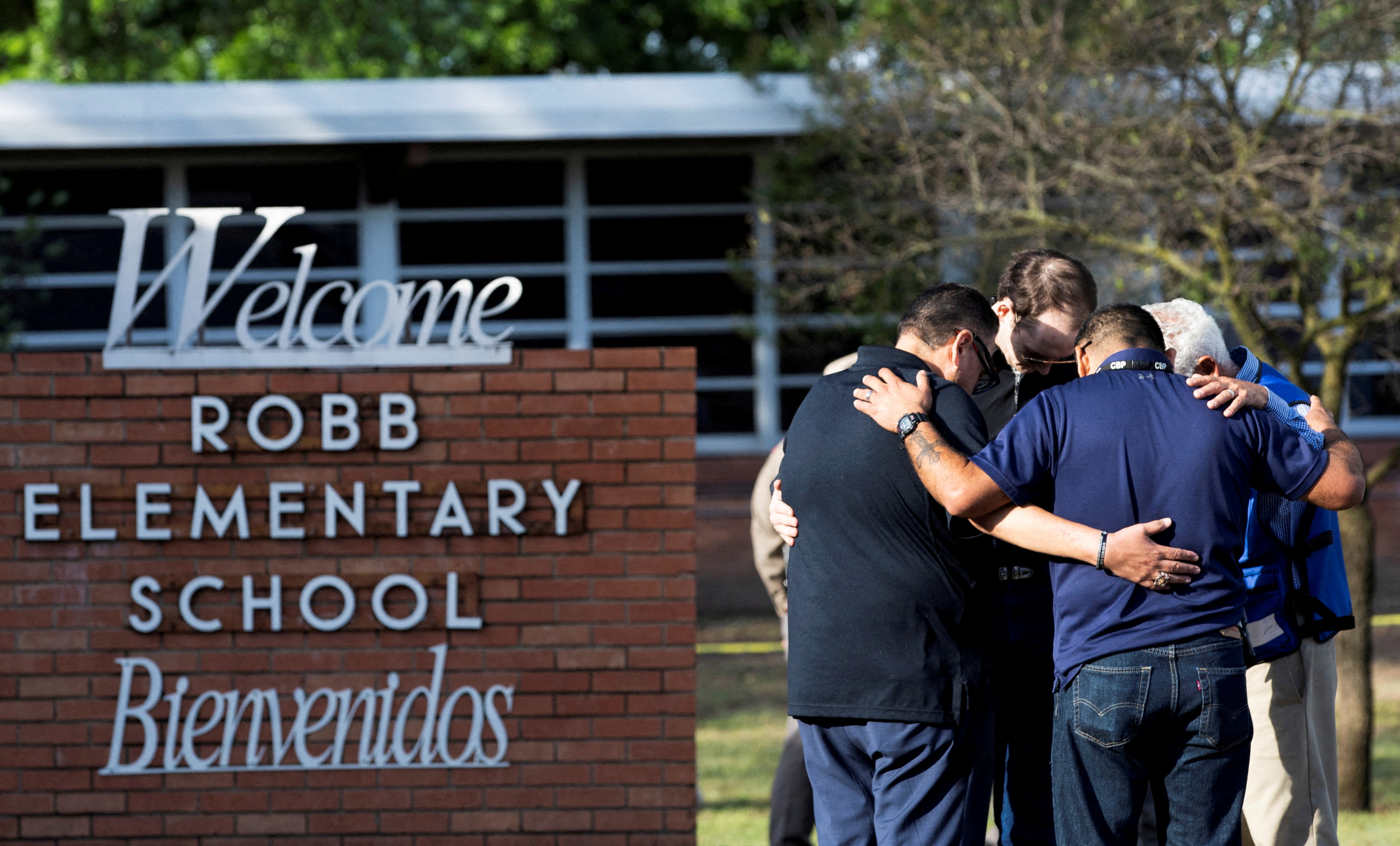People gather at Robb Elementary School, the scene of a mass shooting in Uvalde, Texas, U.S.