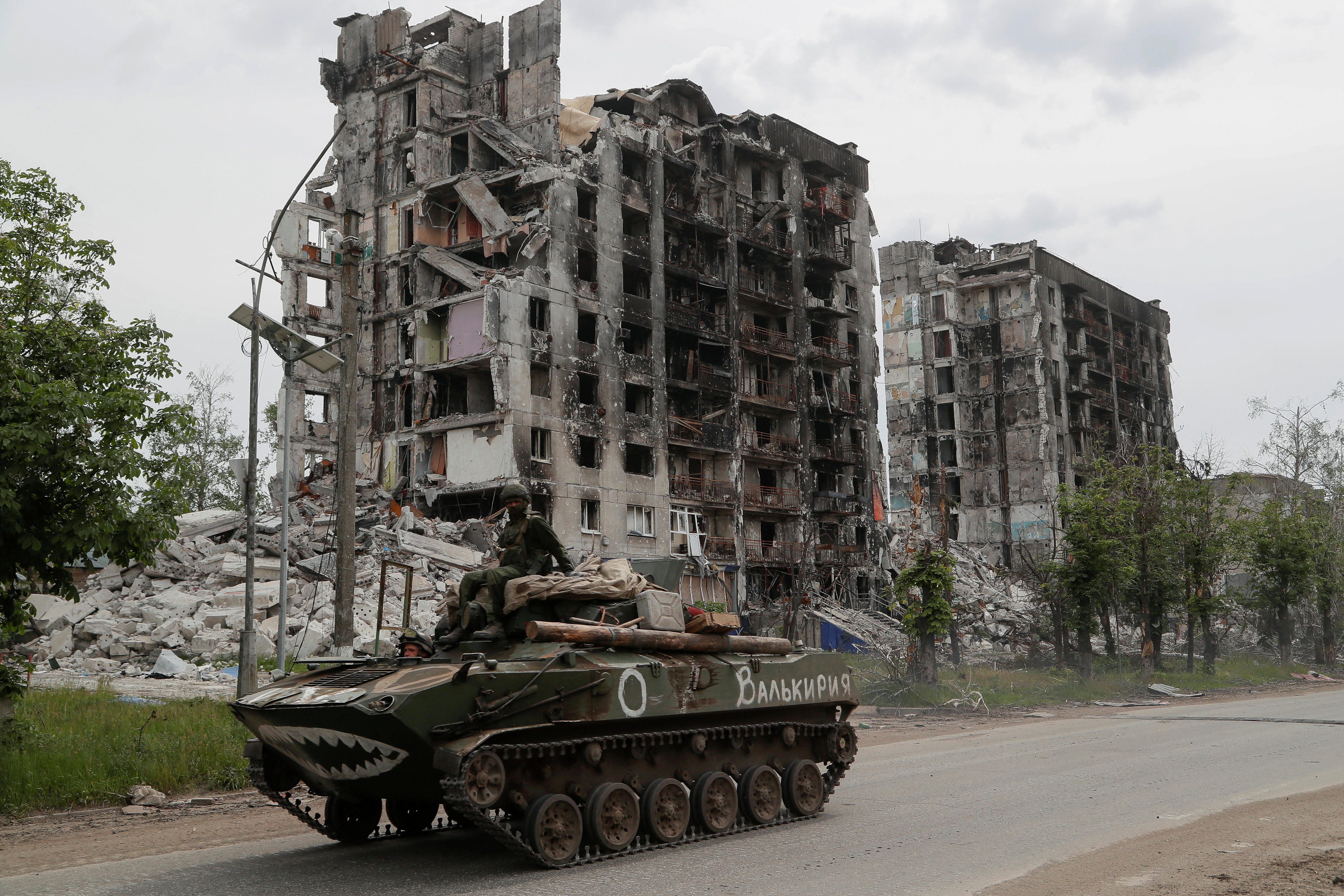 Pro-Russian troops drive an armoured vehicle along in the town of Popasna in the Luhansk Region, Ukraine May 26, 2022. The writing on the vehicle reads: "Valkyrie" [Alexander Ermochenko/Reuters]