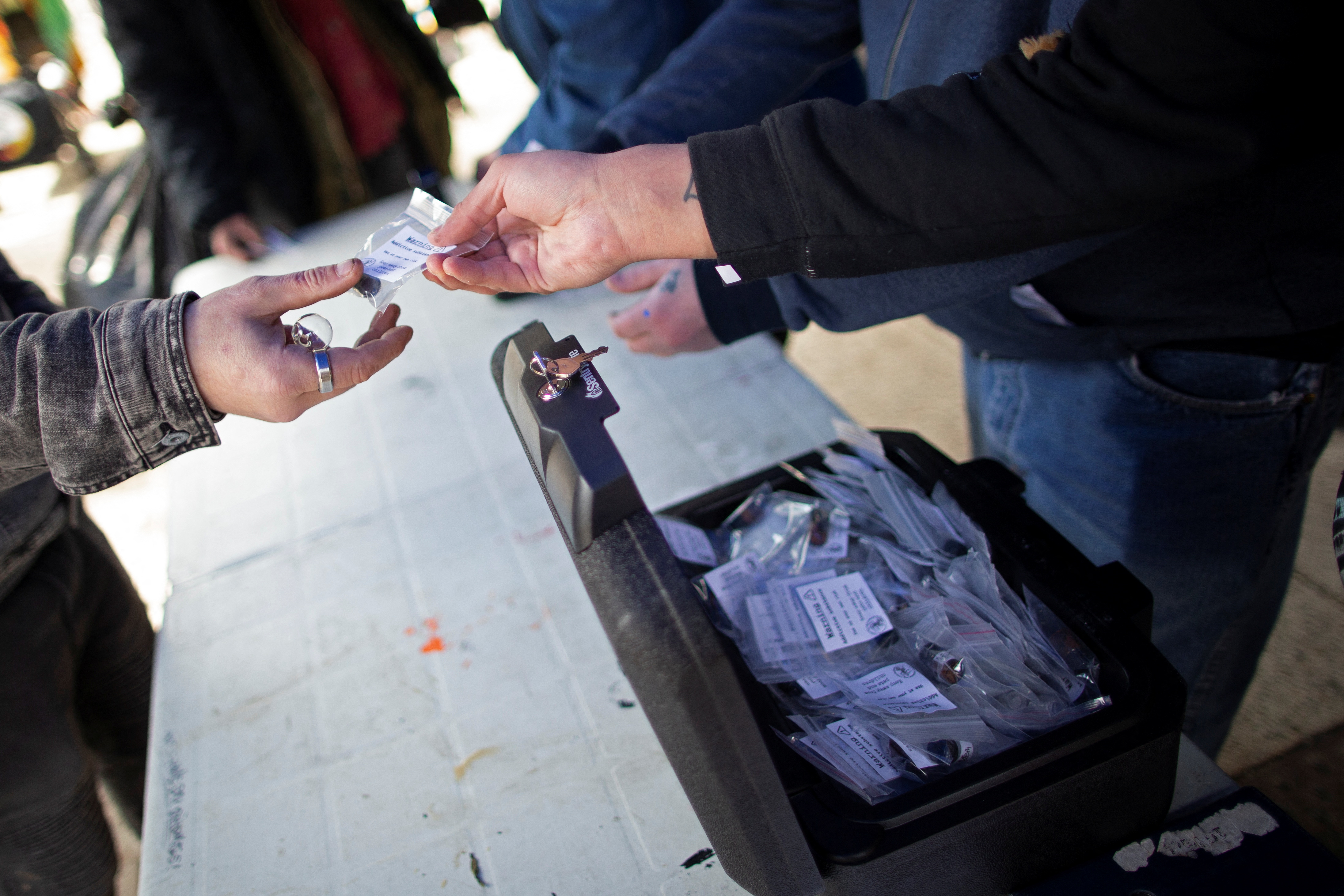 community members hand out clean, tested drug doses at a demonstration