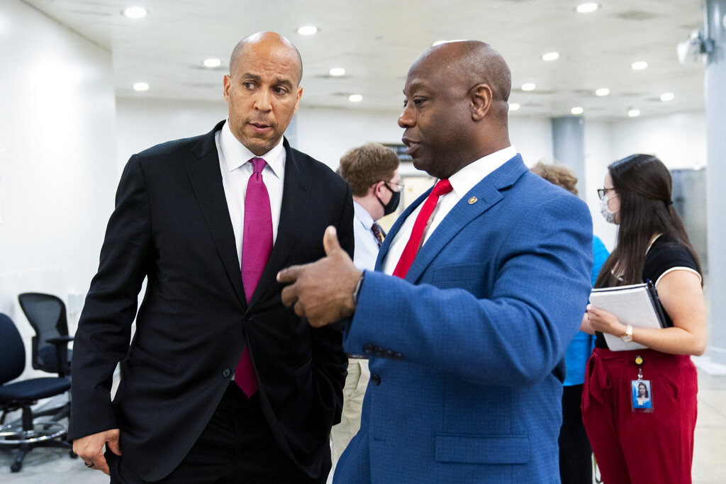 Senator Tim Scott, a Republican, right, and Senator Cory Booker, a Democrat, talk as they wait for a Senate subway train on Capitol Hill in Washington, DC.,