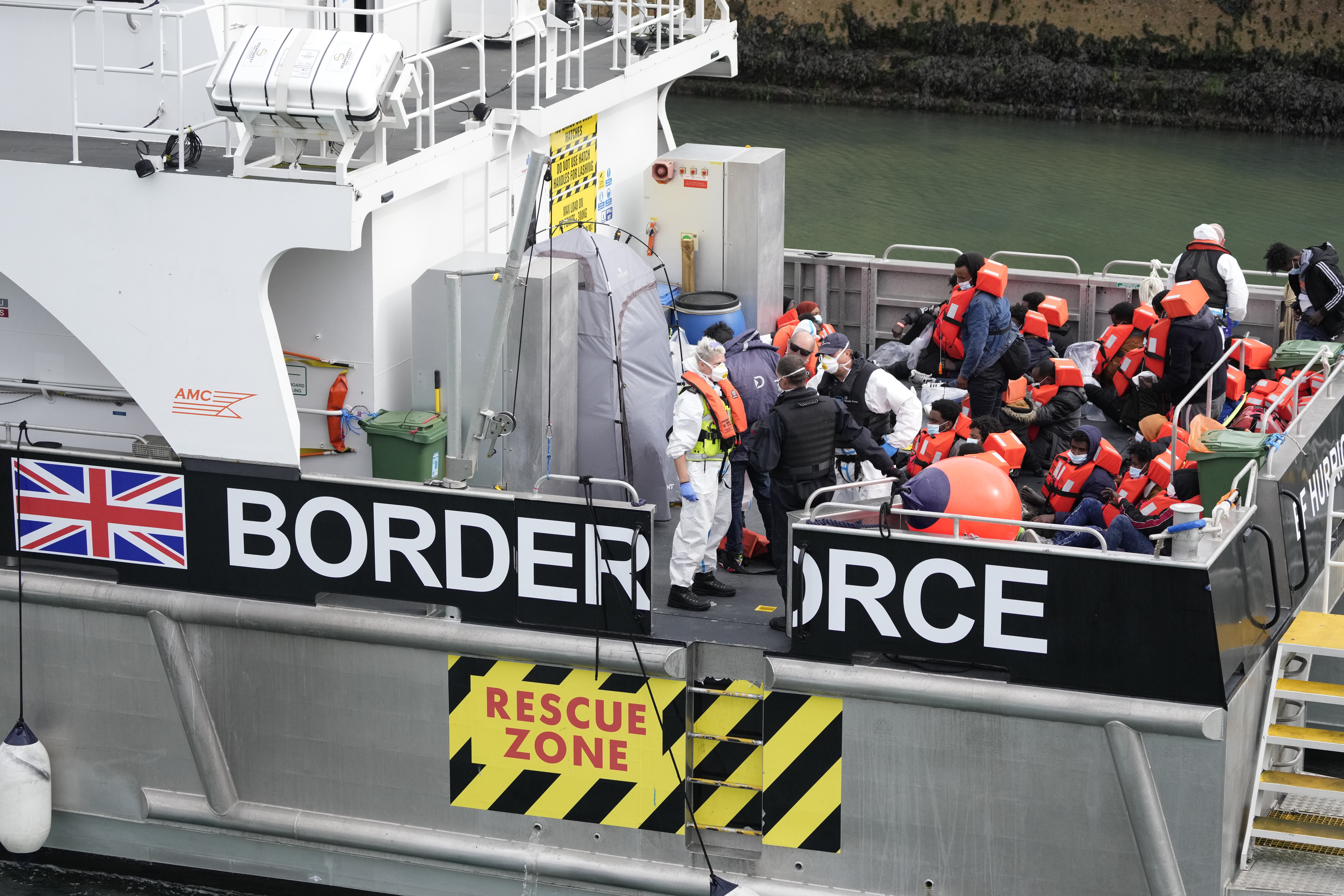 People thought to be refugees and migrants who made the crossing from France are brought into port after being picked up in the Channel by a UK border force vessel in Dover, south east England.