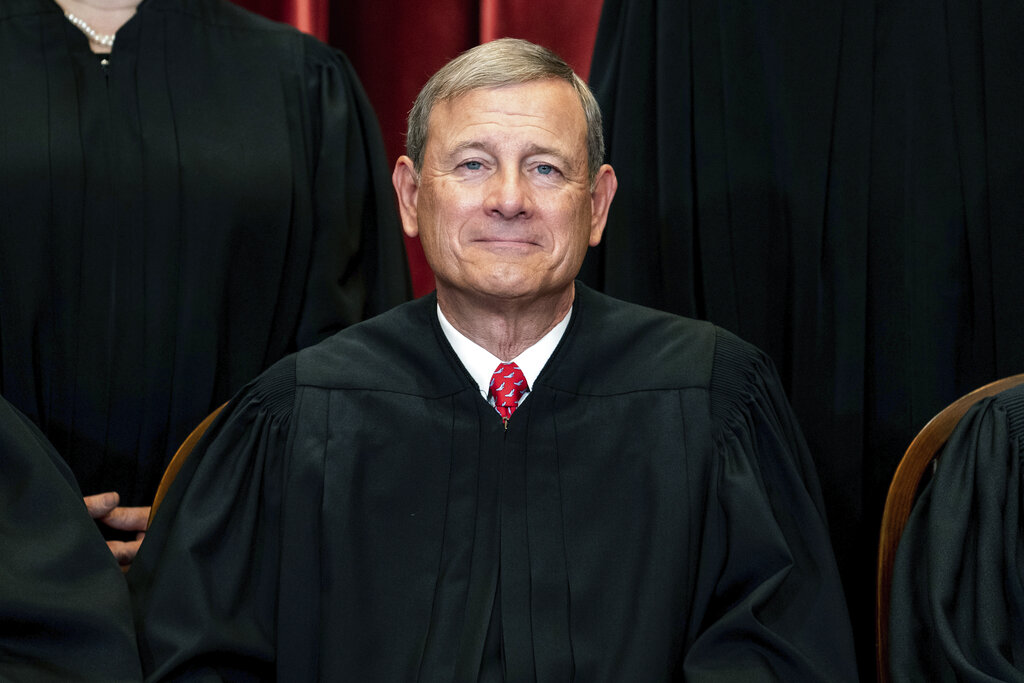 Chief Justice John Roberts sits during a group photo at the Supreme Court in Washington., DC