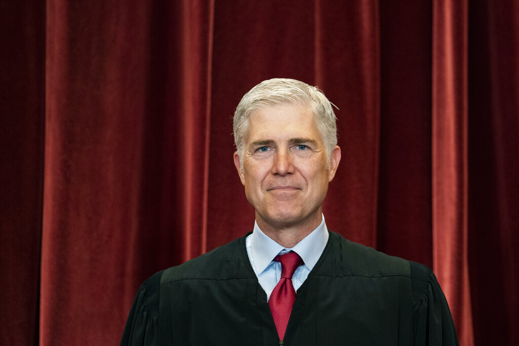 Associate Justice Neil Gorsuch stands during a group photo at the Supreme Court.