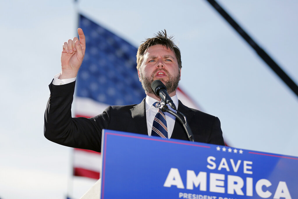 Republican Senate candidate JD Vance points his finger in the air as he speaks at a rally.