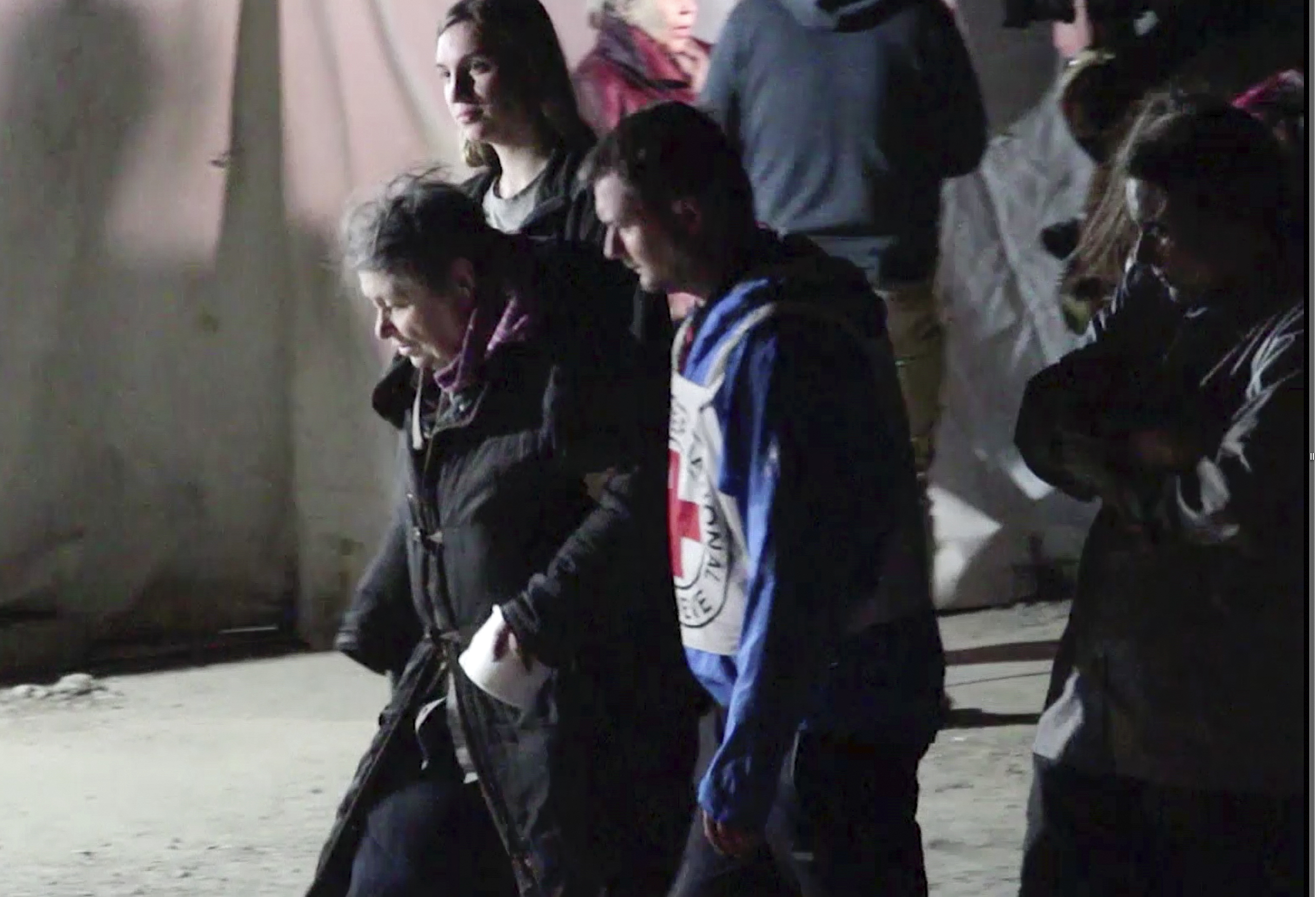 In this photo taken from video, civil evacuees accompanied by Red Cross personnel walk in an area controlled by Russian-backed separatist forces in Bezimenne, about 20 kilometres (12 miles) east of Mariupol, eastern Ukraine, Saturday, April 30, 2022 [AP Photo]