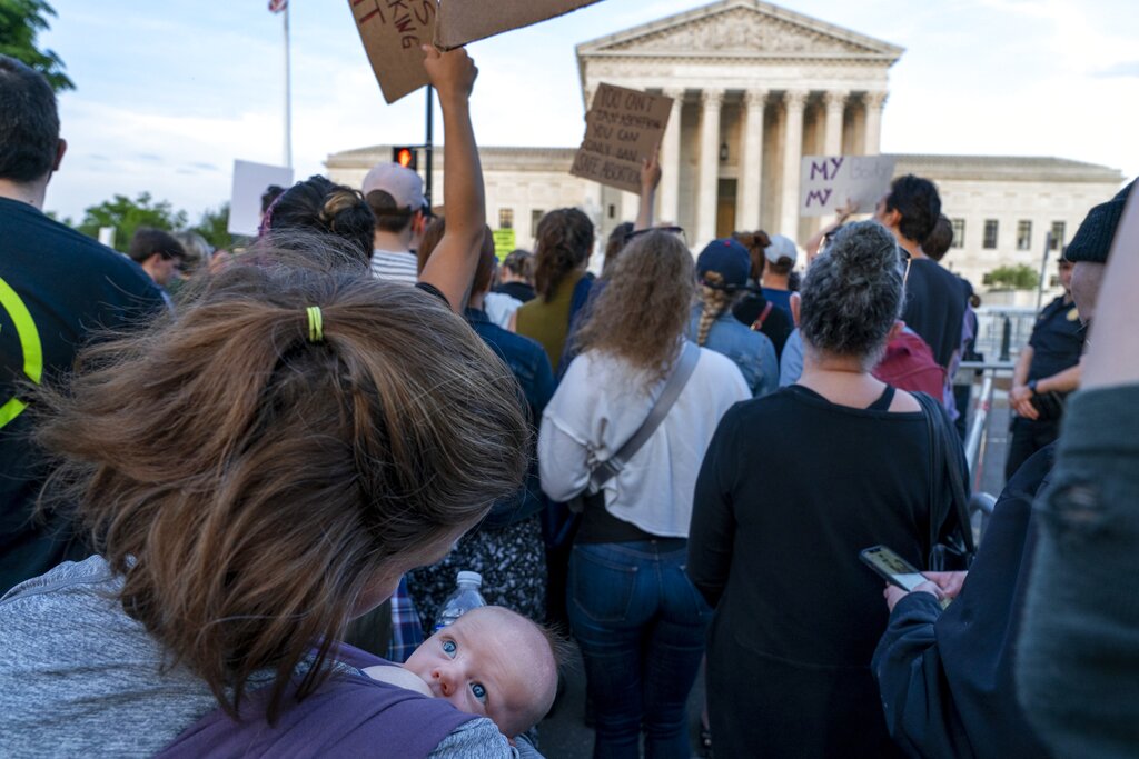 Katie McDevitt of Washington, nurses her 6-week-old baby Declan, as they join demonstrators protesting outside of the US Supreme Court.