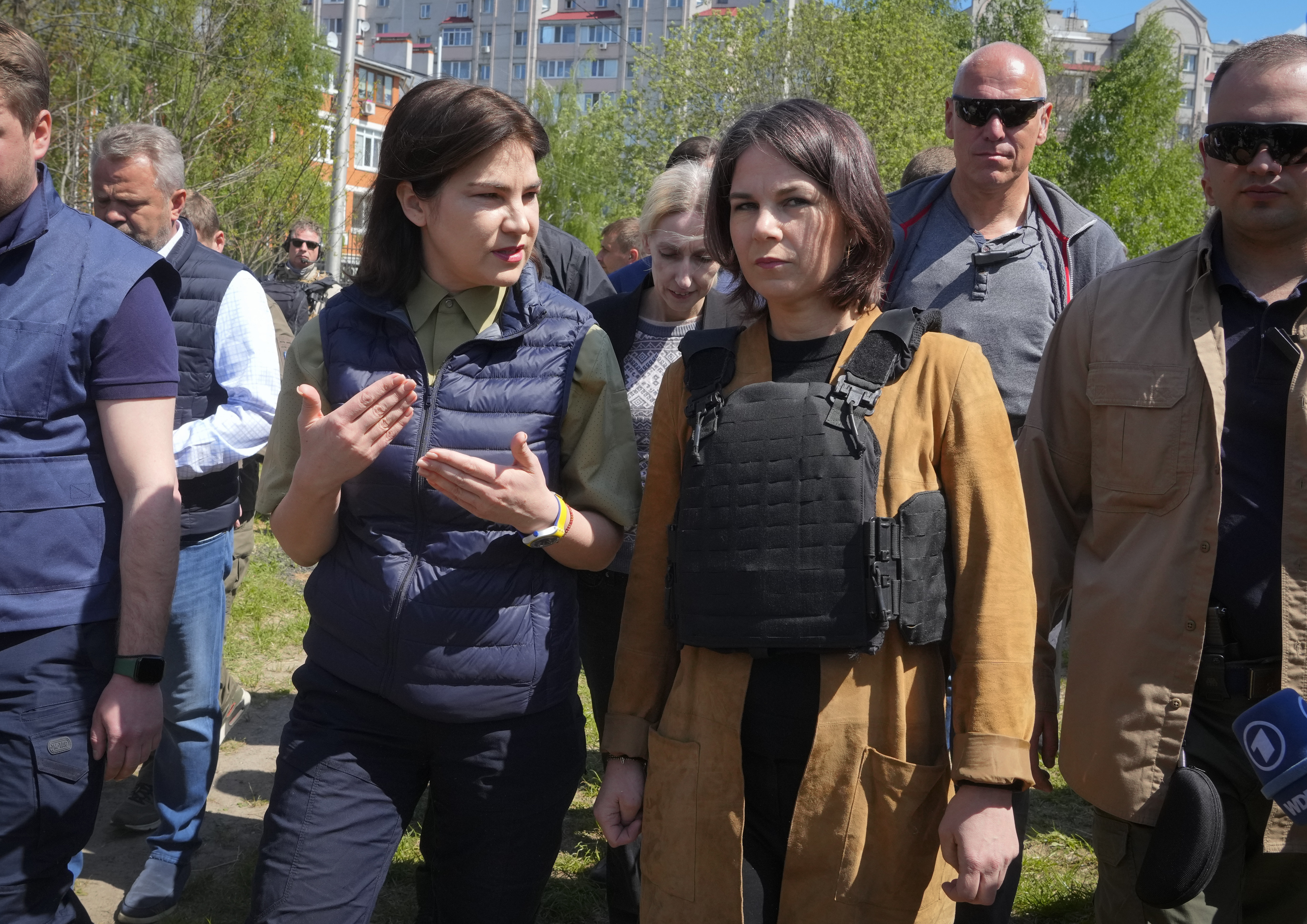 German Foreign Minister Annalena Baerbock and Ukrainian Prosecutor General Iryna Venediktova talk as they stand near a mass grave in Bucha, on the outskirts of Kyiv, Ukraine