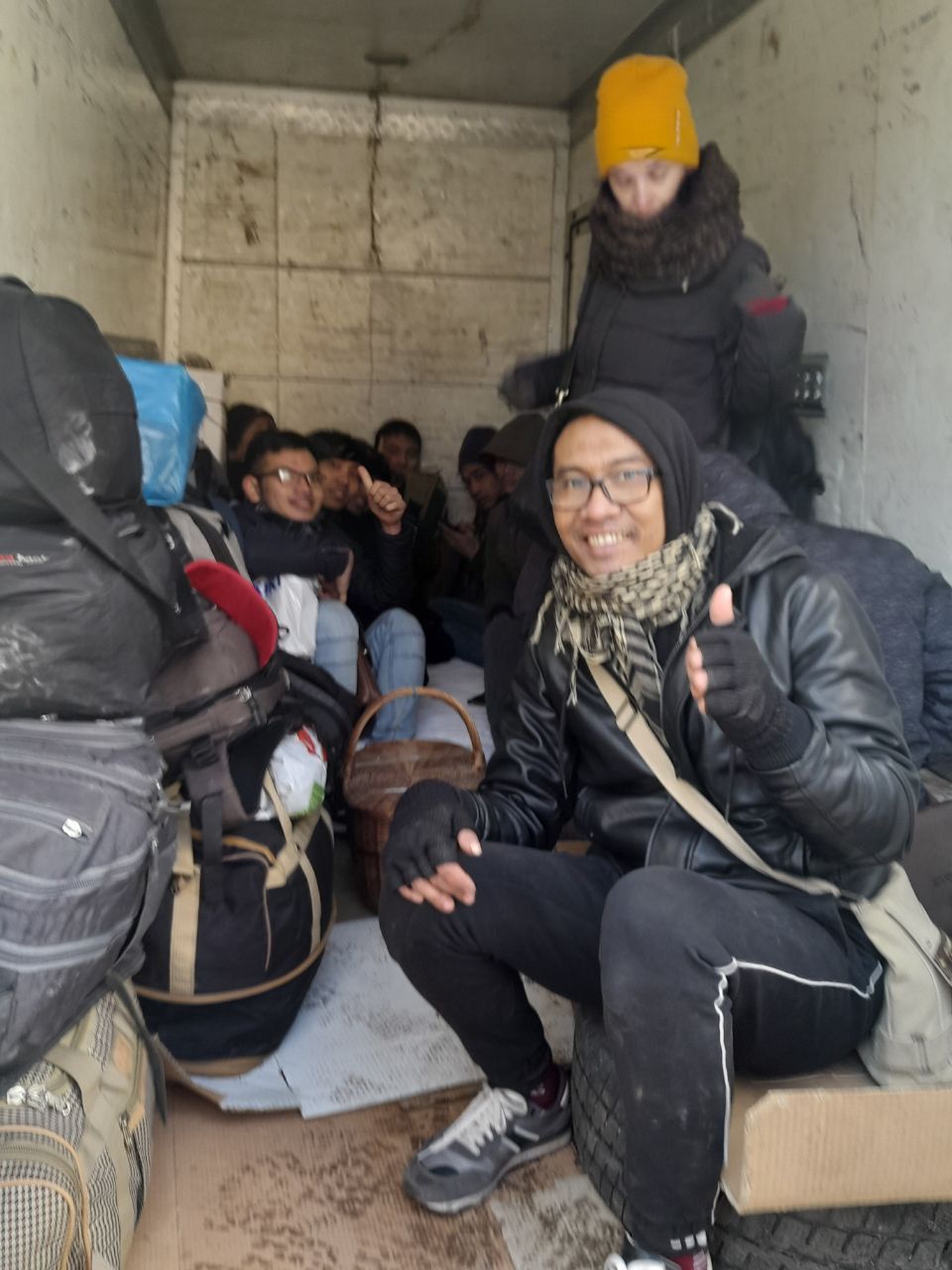 Iskandar in black sweat pants and winter coat as they are evacuated from the plastics factory with his colleagues