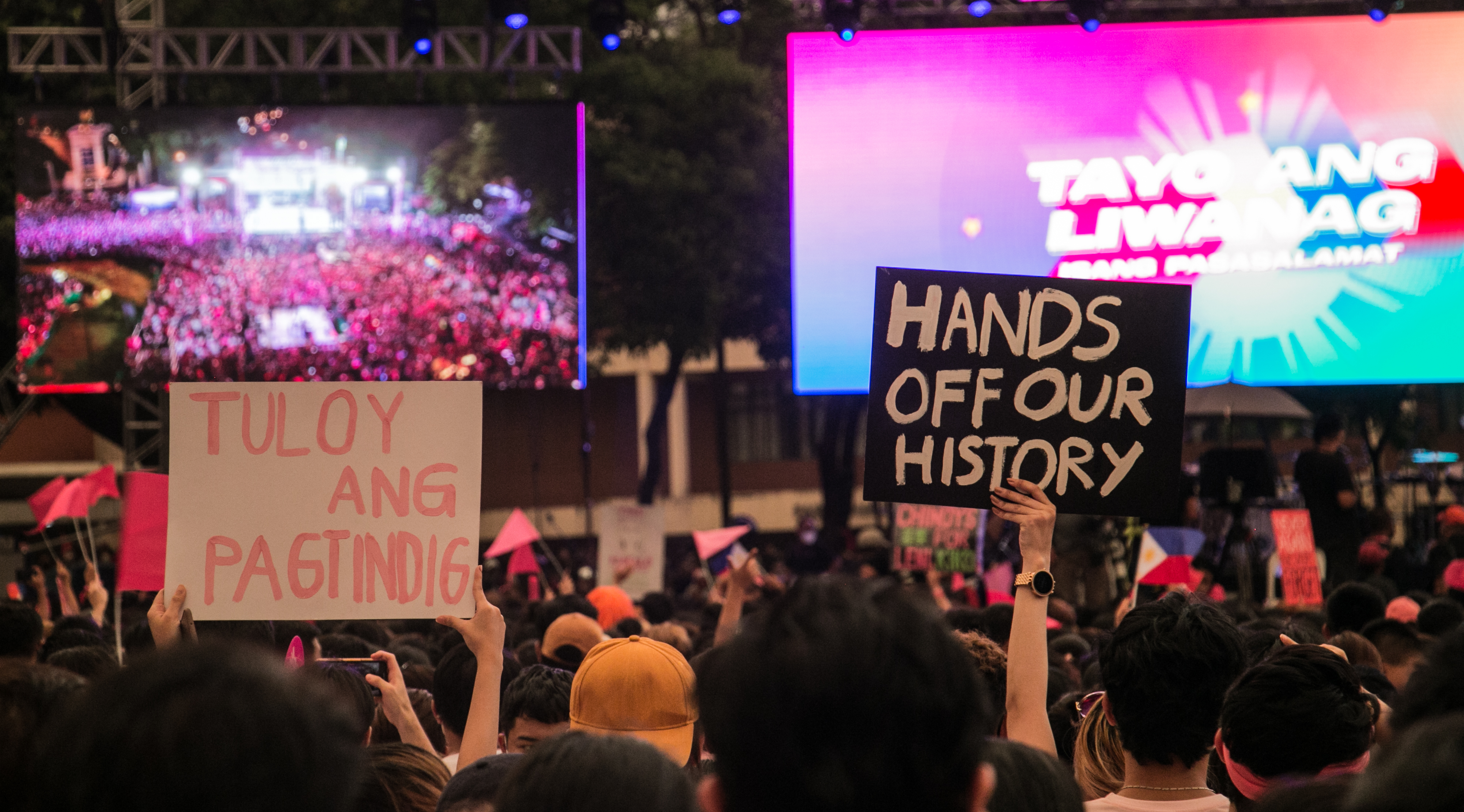 A young crowd at a political rally protest at efforts to revise history carrying placards saying 'Hands off our History'