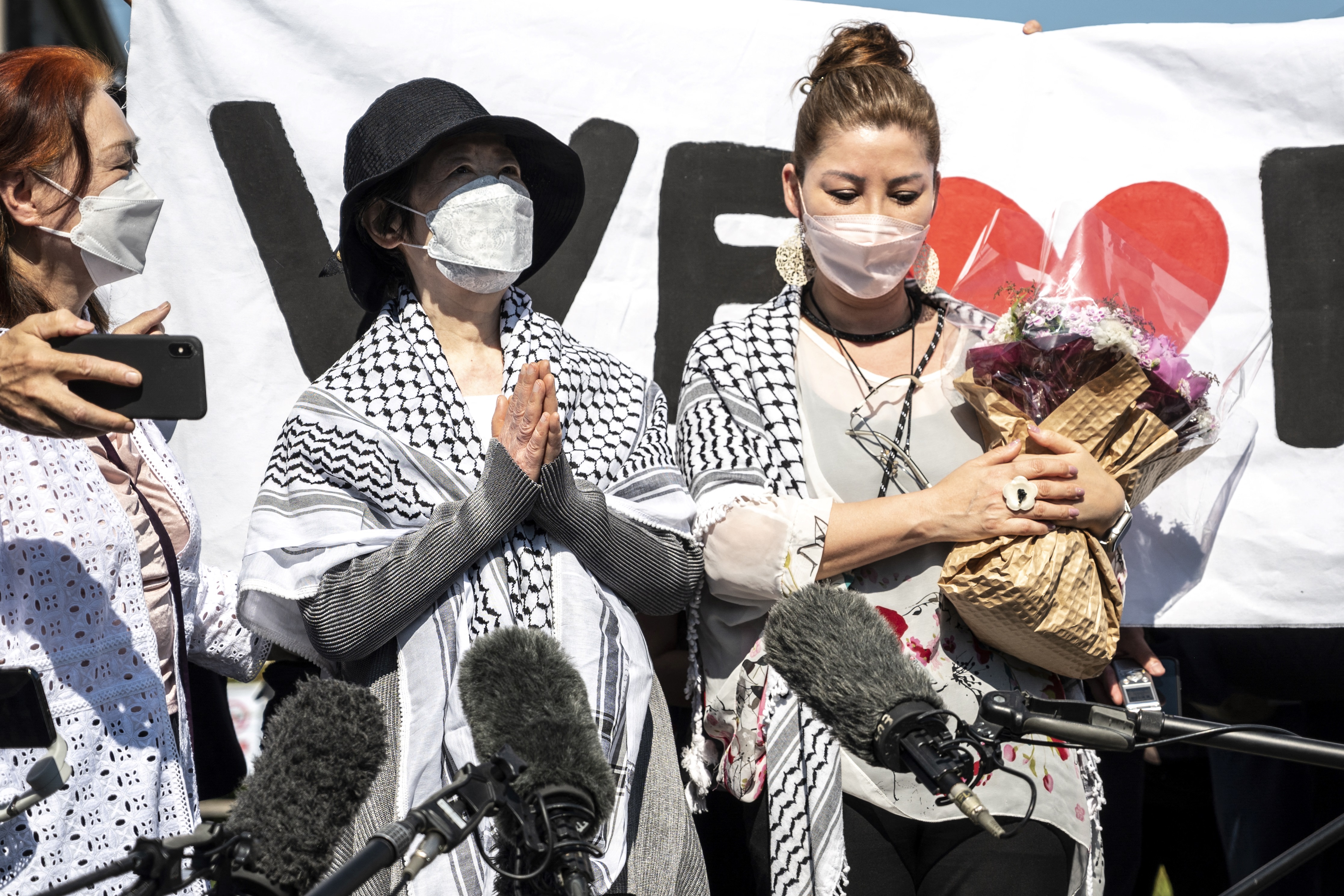 Japanese Red Army founder Fusako Shigenobu gestures after her release with her daughter May Shigenobu on Saturday
