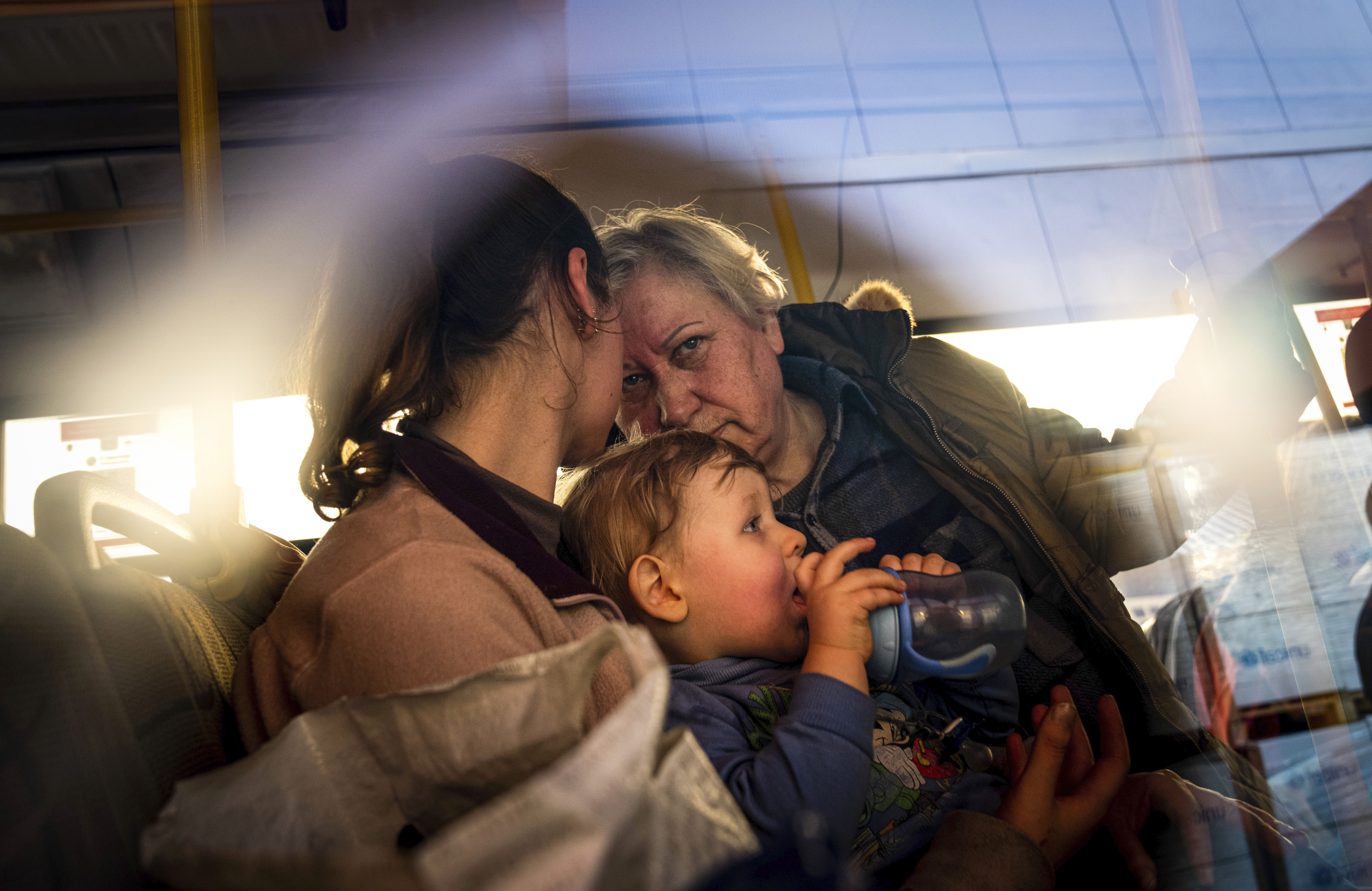 People with children after arriving from the Ukrainian city of Mariupol at a centre for displaced people in Zaporizhzhia.
