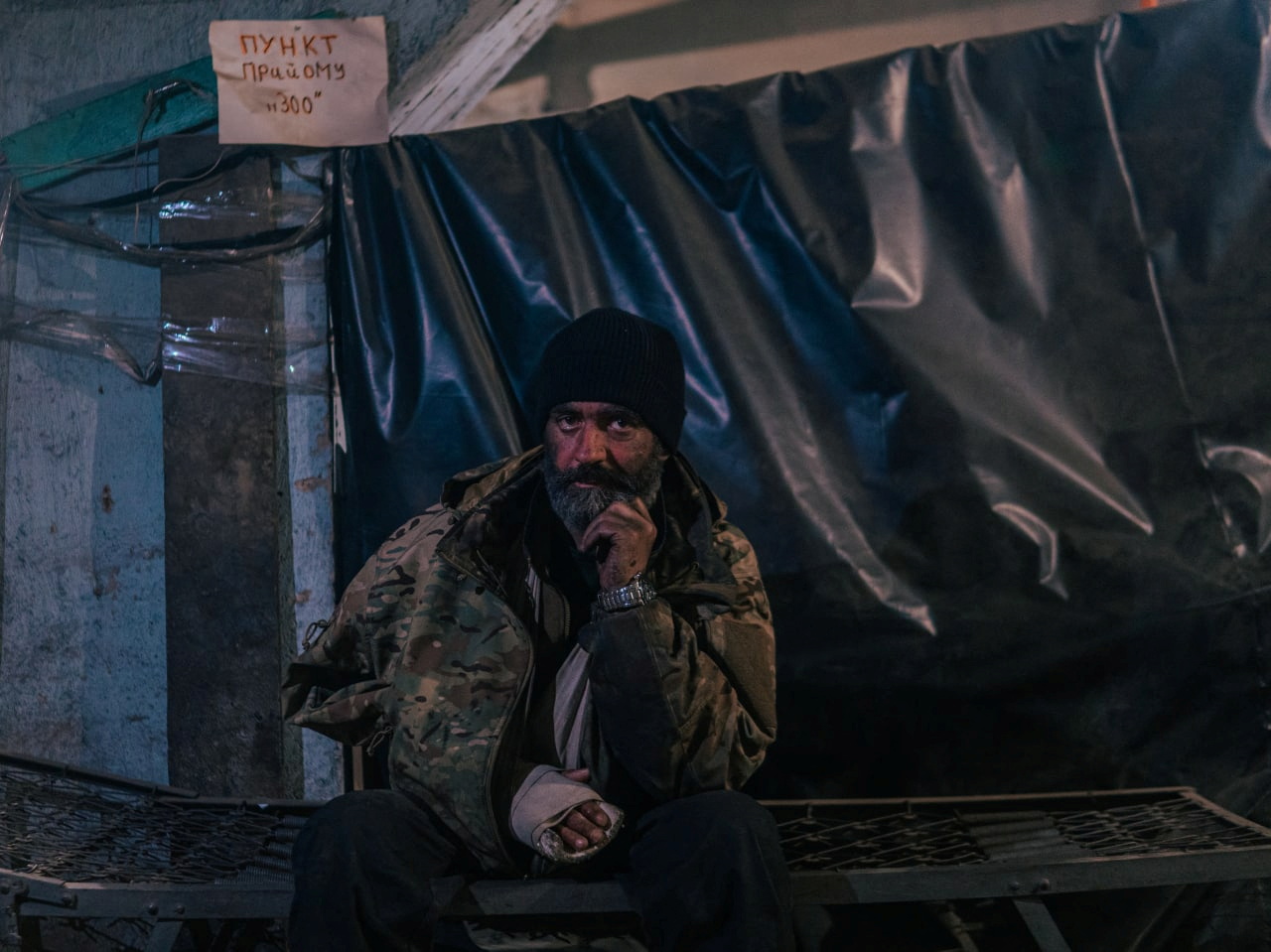 An injured Ukrainian service member sits at a field hospital inside a bunker of the Azovstal Iron and Steel Works in Mariupol, Ukraine, May 10, 2022