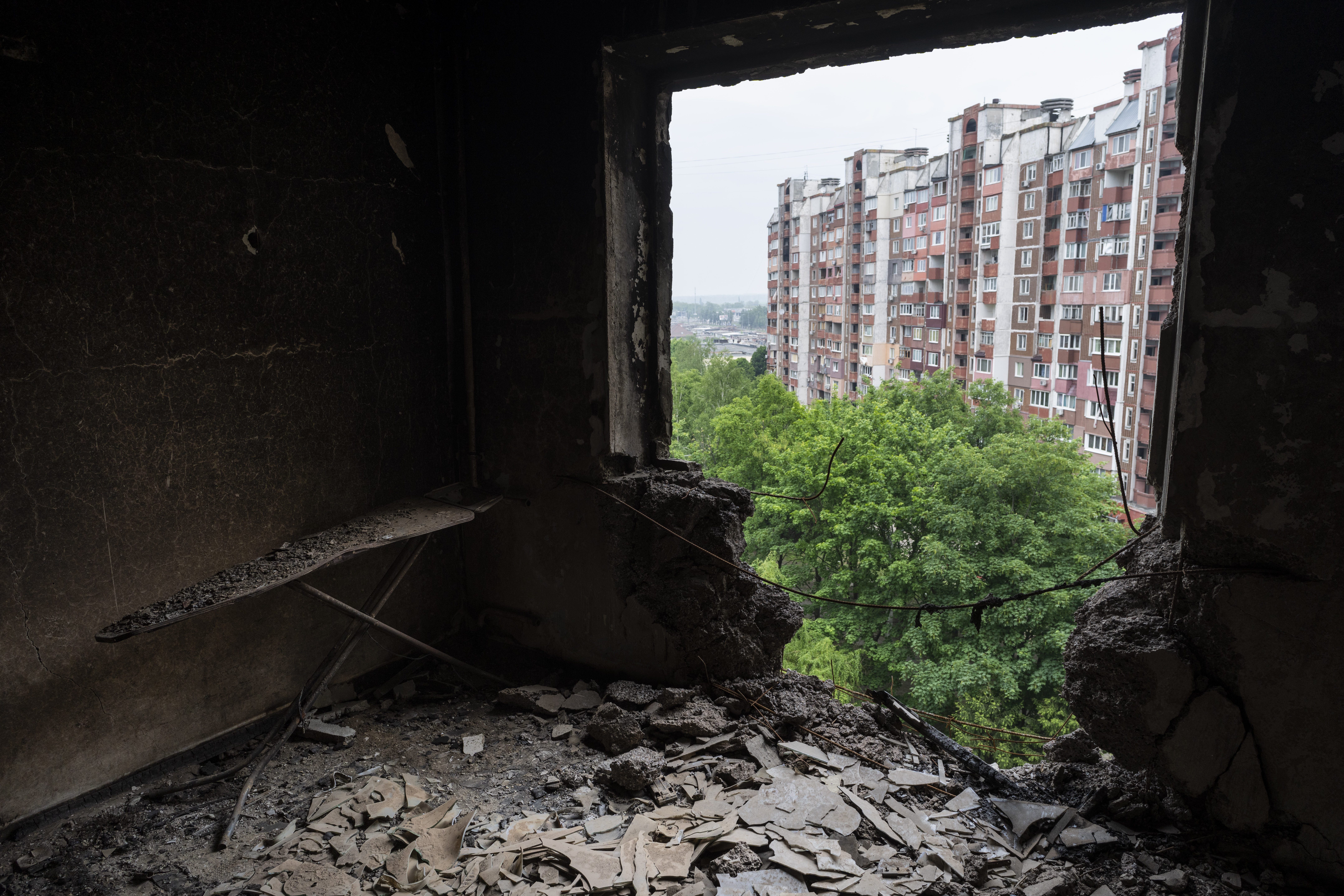 Debris cover the room of an apartment damaged during shelling in Kharkiv, eastern Ukraine, Saturday, May 21, 2022 