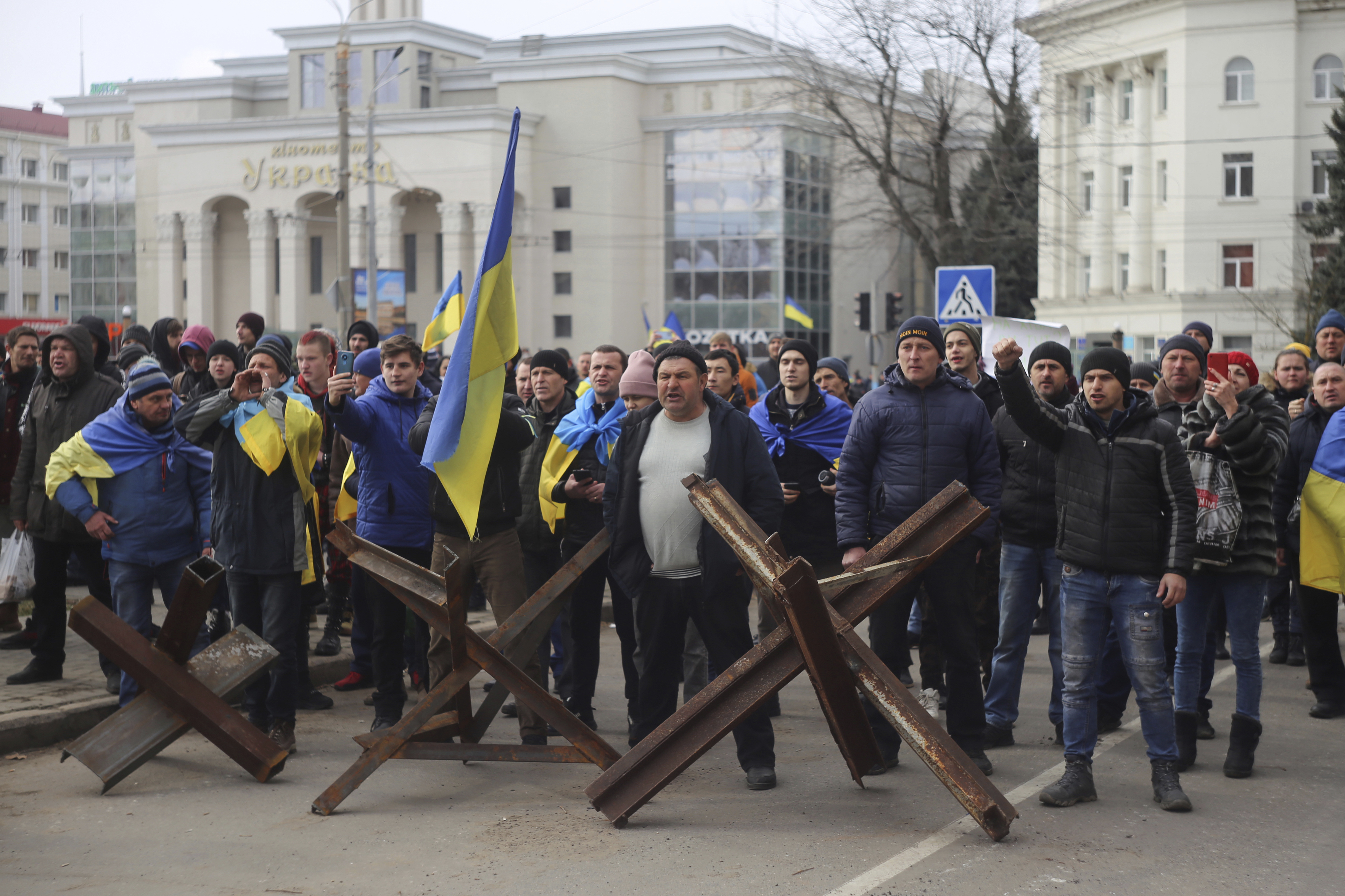 People shout at Russian soldiers during rally against the Russian occupation in Svobody (Freedom) Square in Kherson, Ukraine, Monday, March 7, 2022