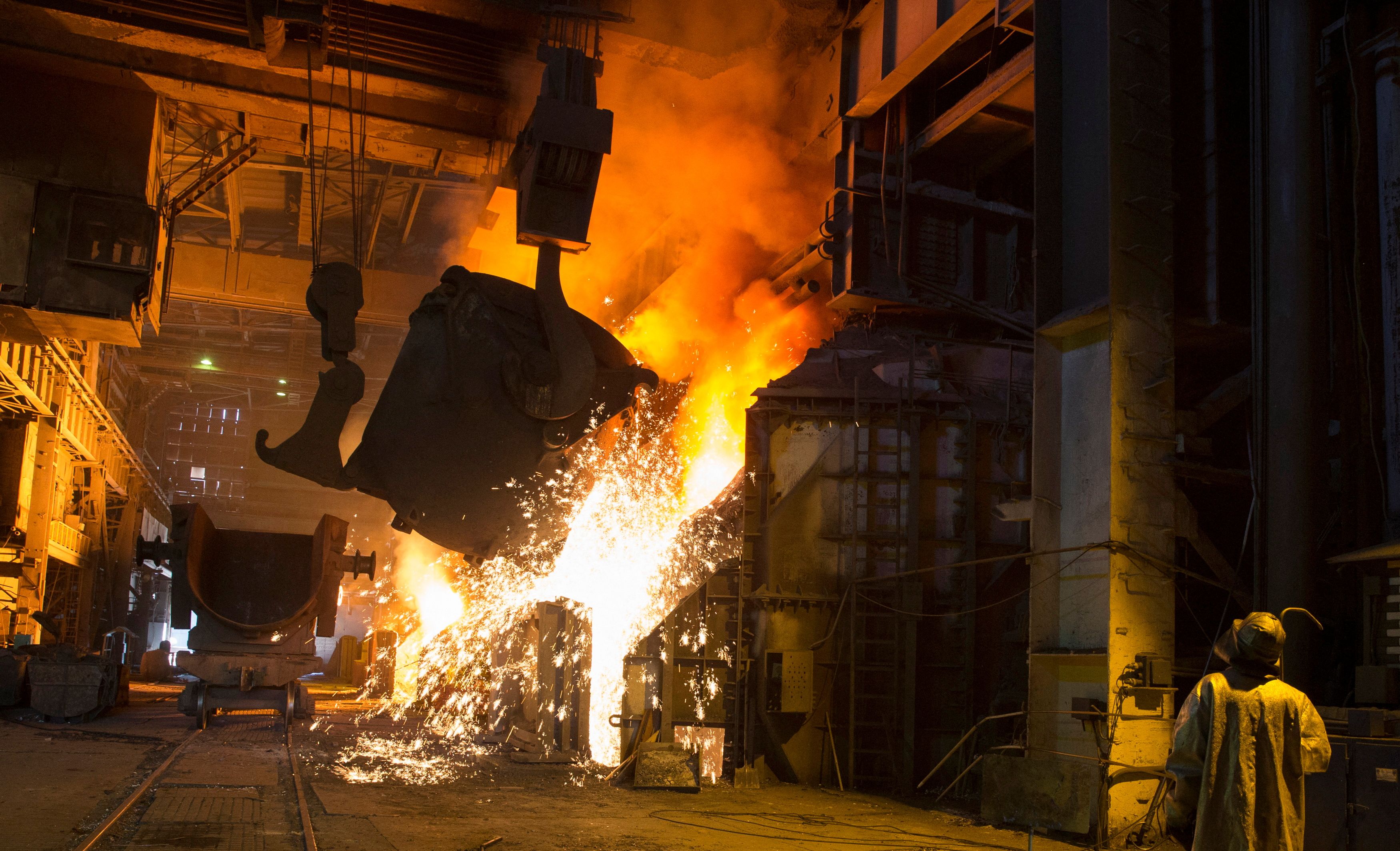 A steelworker operates machinery at the Ilich iron and steel plant in the southern coastal town of Mariupol
