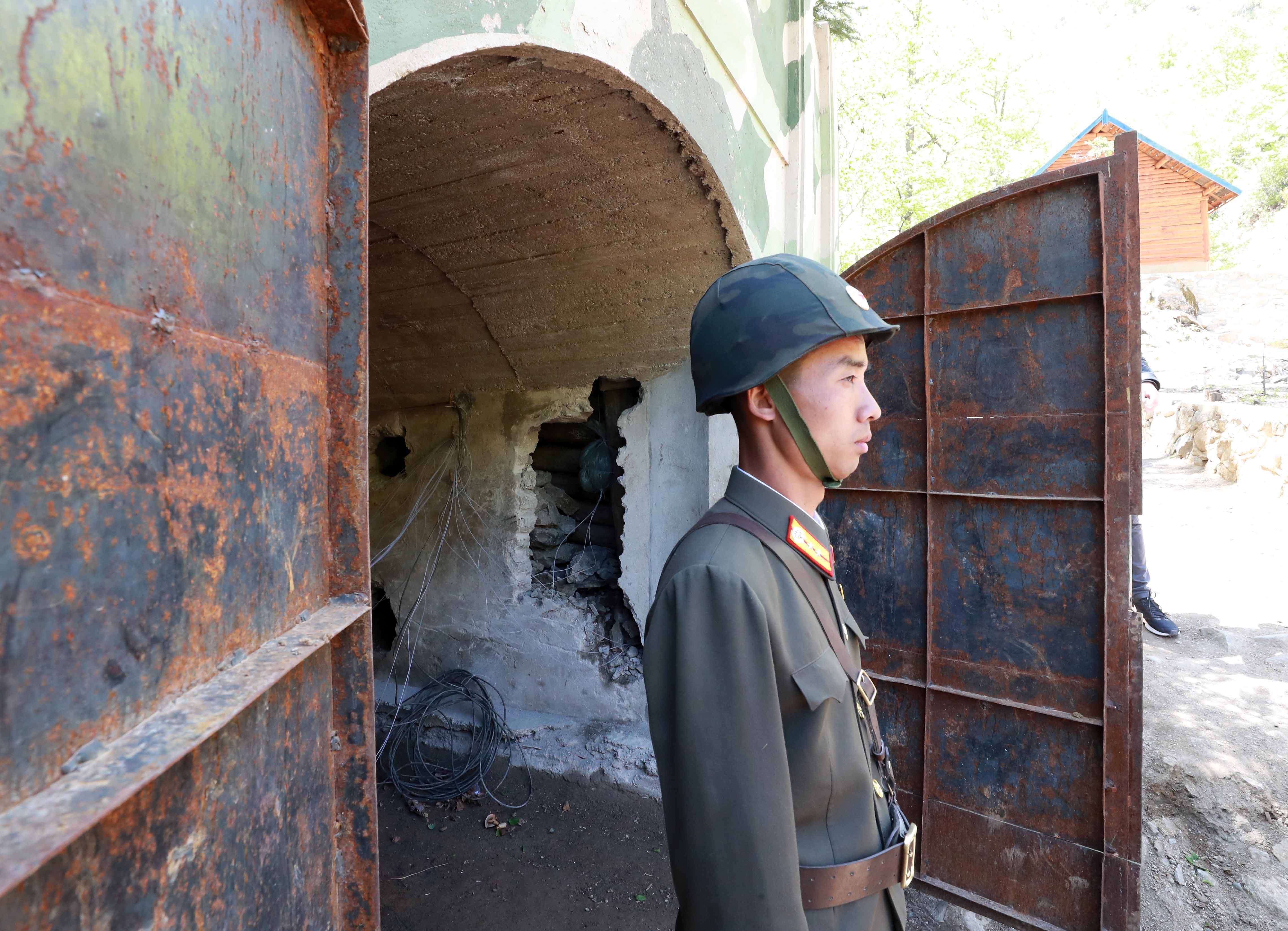 A North Korea People's Army (KPA) soldier standing at the entrance to a tunnel at the Punggye-ri nuclear test facility ahead of its demolition in 2018.