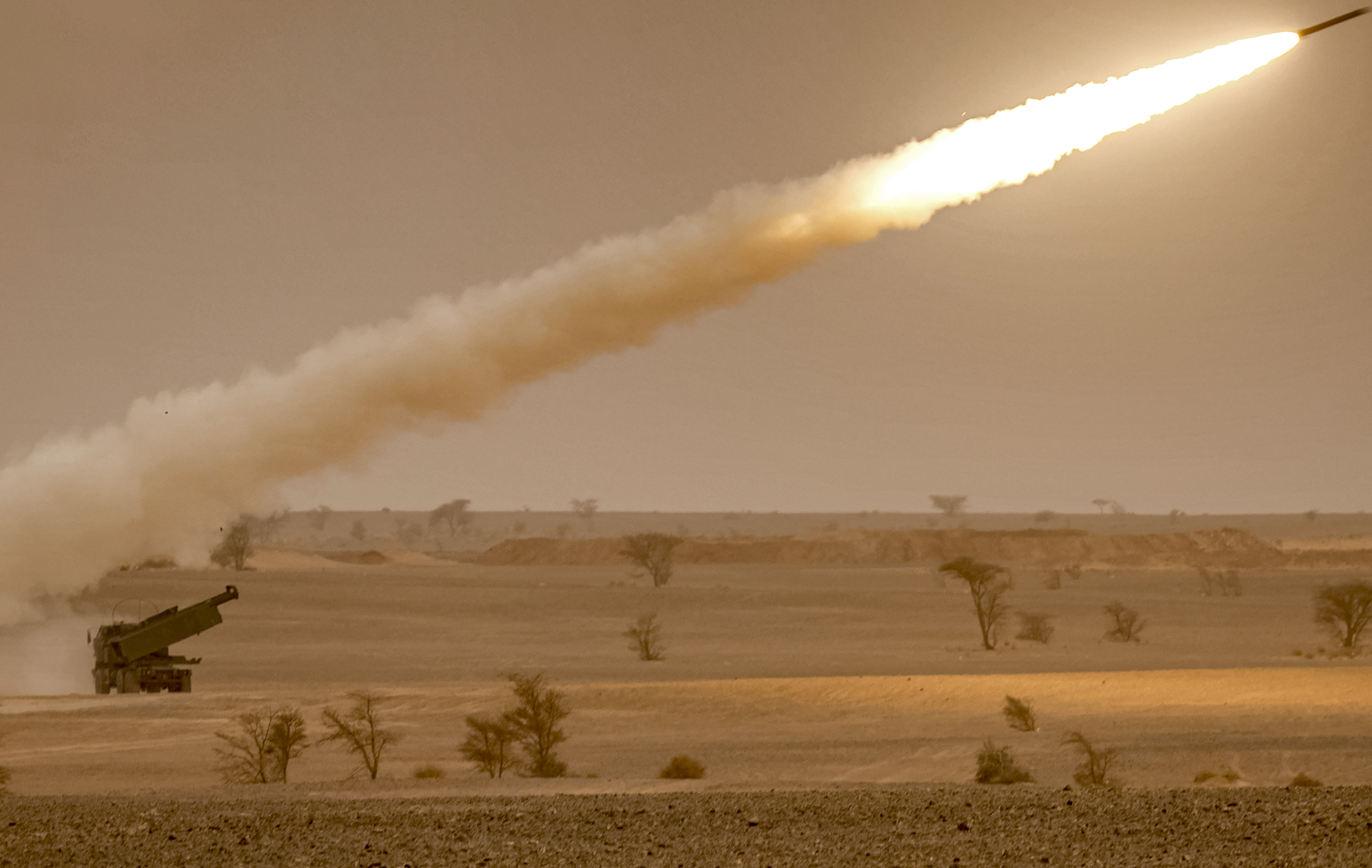 US M142 High Mobility Artillery Rocket System (HIMARS) launchers fire salvoes during a military exercise.