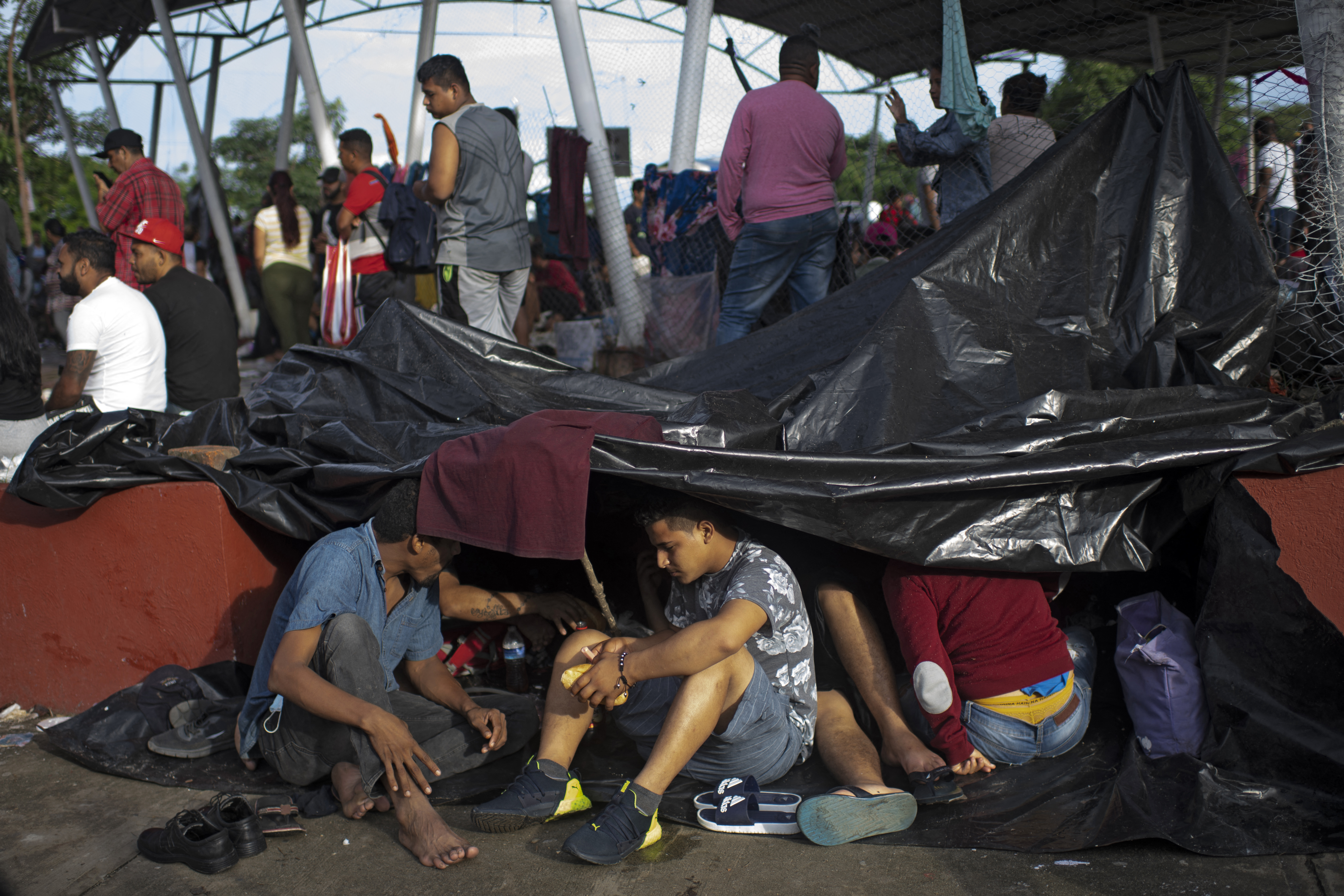Migrants taking part in a caravan heading to the US, are seen at a makeshift camp in Huixtla, Chiapas state