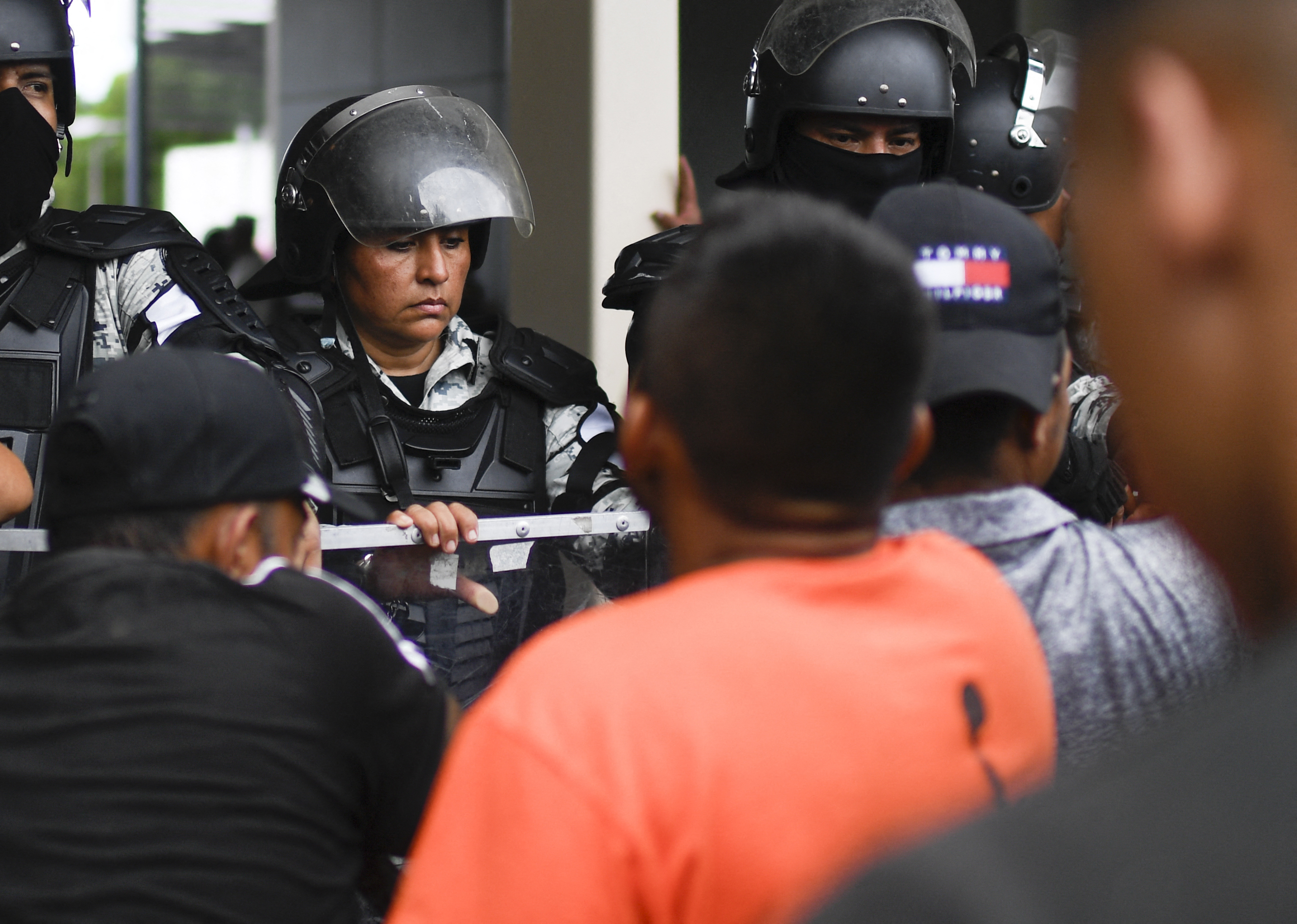 Migrants taking part in a caravan heading to the US, wait for transit visas outside the immigration station