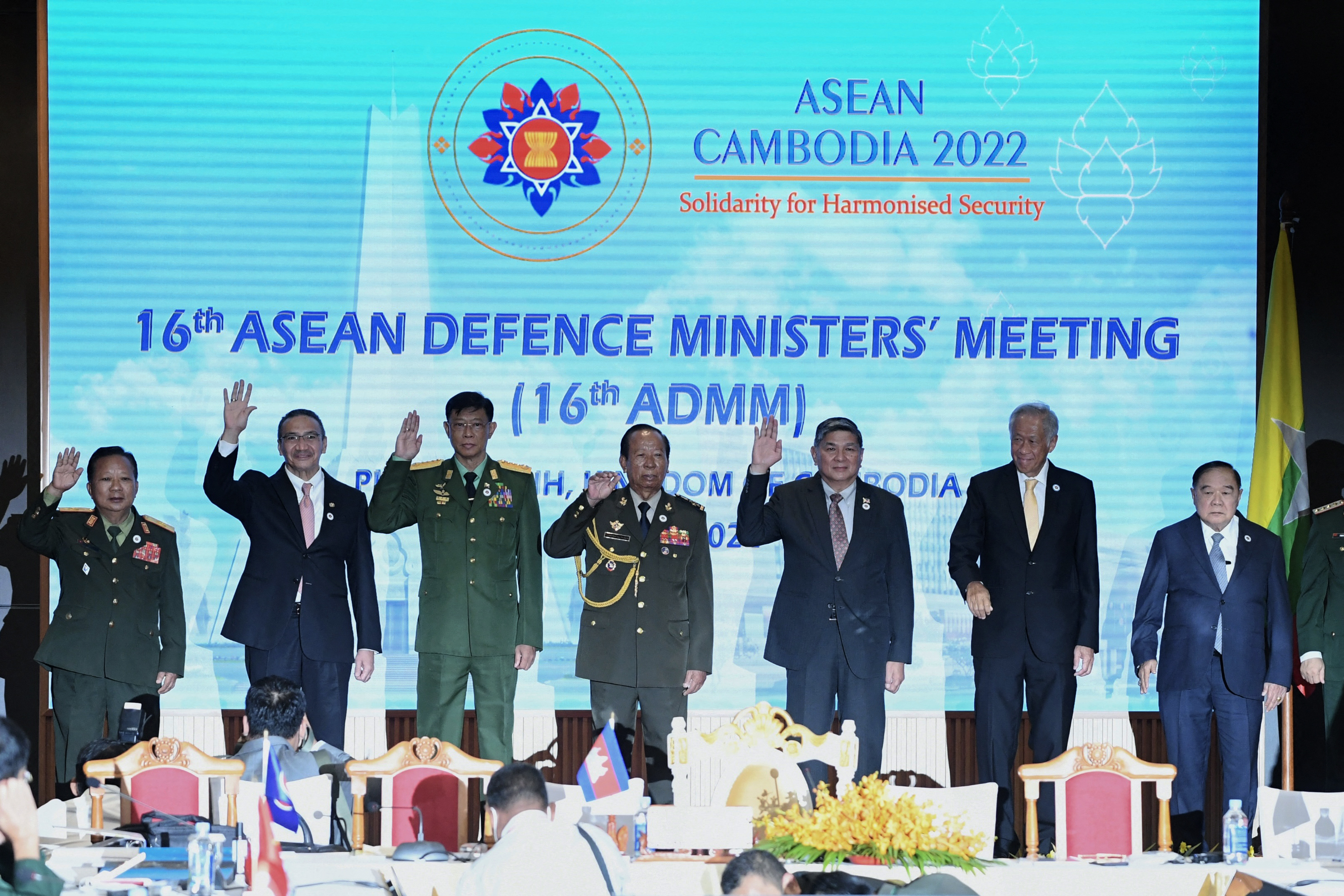 Myanmar's military-appointed defence minister waves alongside his ASEAN counterparts at a meeting this week 
