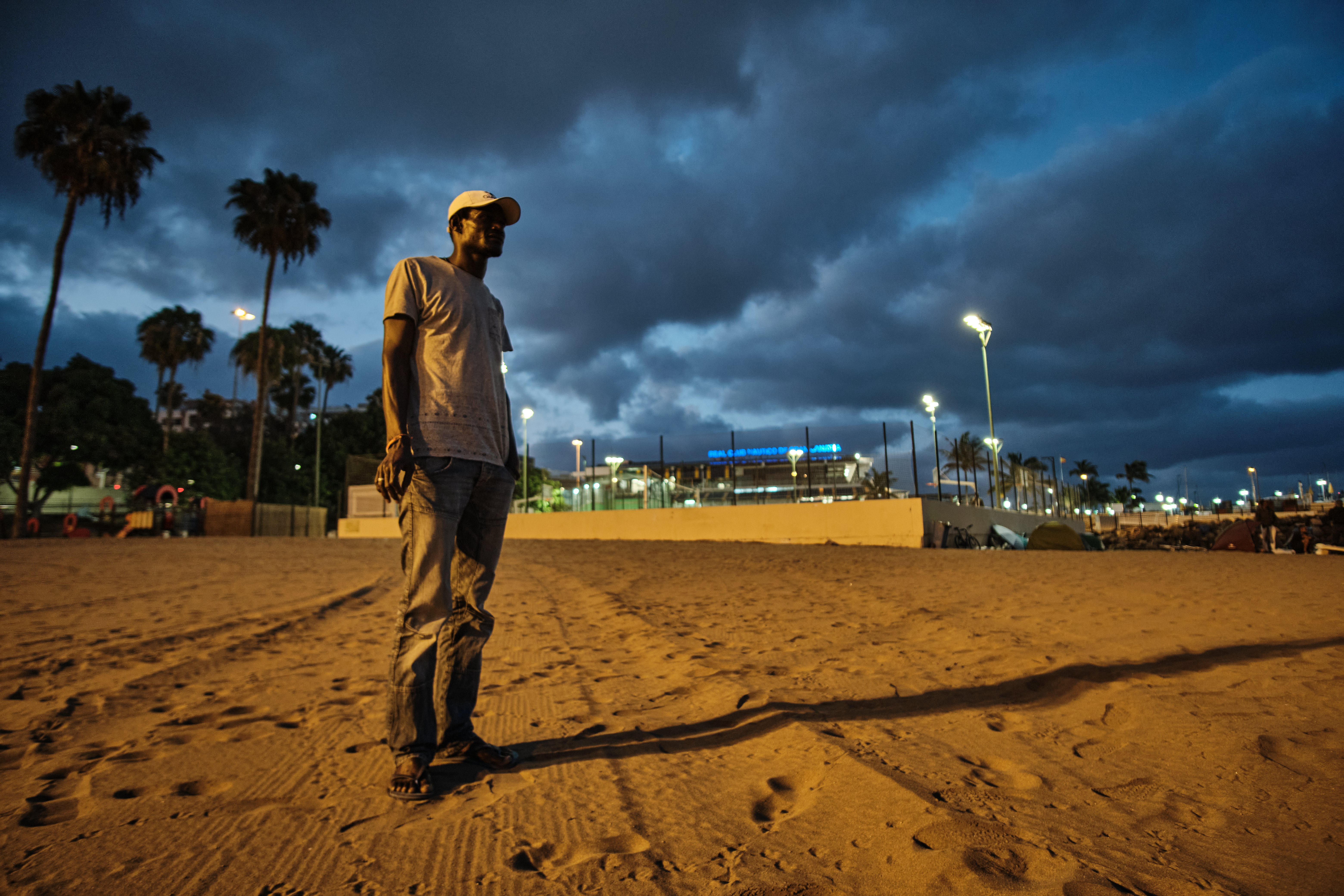 A photo of Ousmane, standing on a beach.