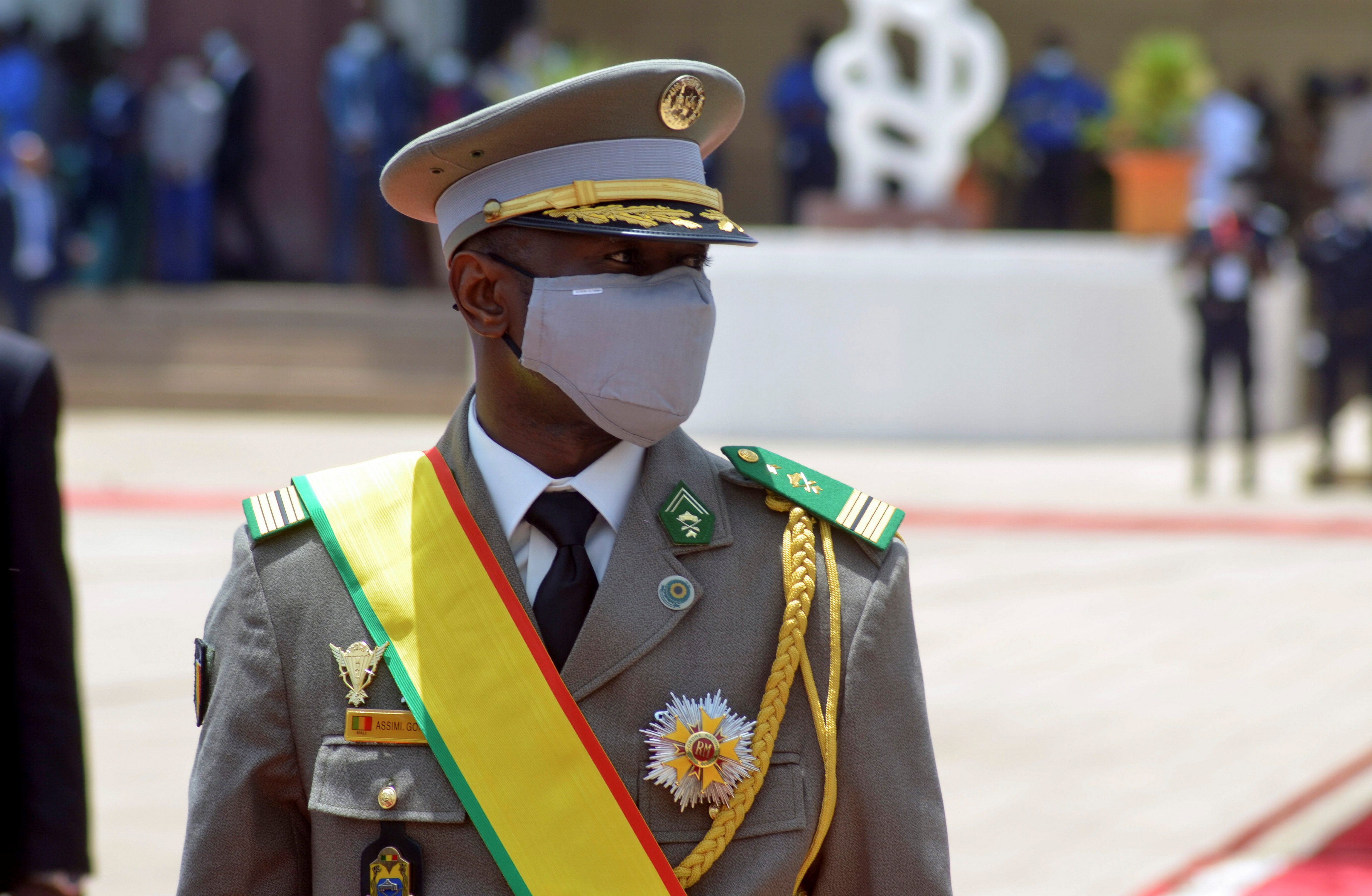 Mali coup leader Colonel Assimi Goita, in uniform with a yellow sash across his shoulder, at a ceremony where he became president.