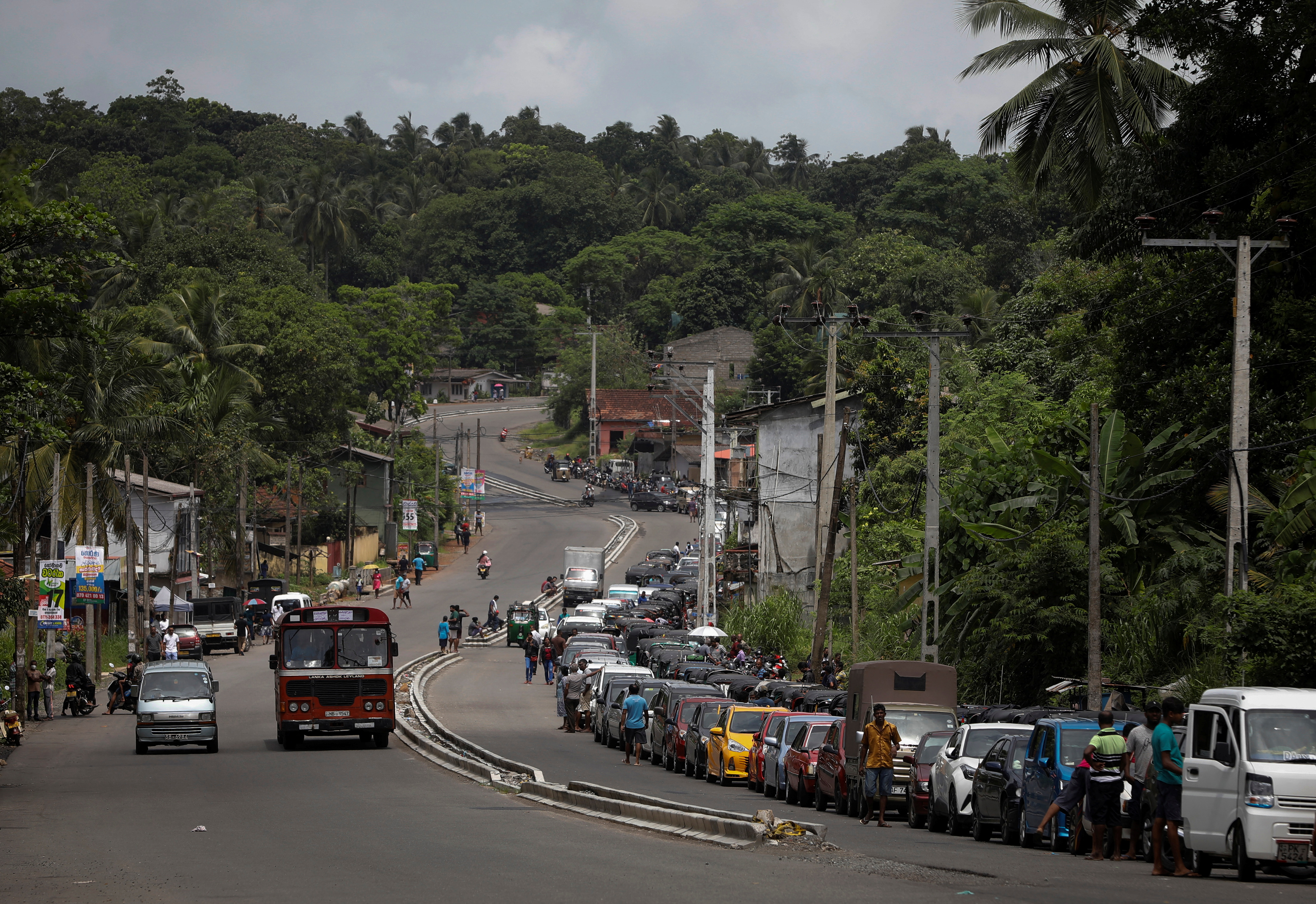 Vehicles queue to buy petrol at a fuel station in Gonapola town, on the outskirts of Colombo