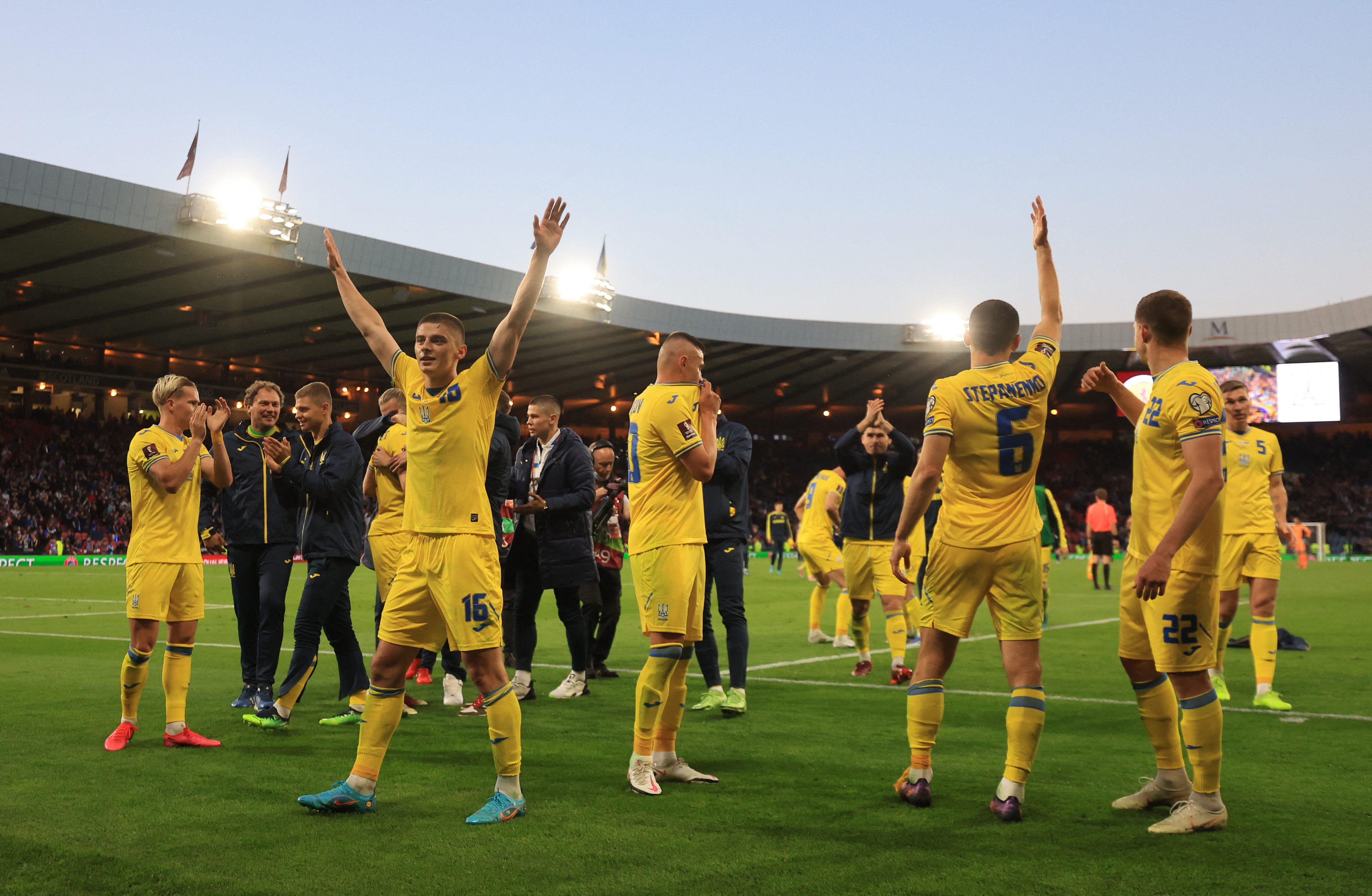 Ukrainian players celebrate on the pitch and wave to fans after their victory over Scotland at Hampden Park in Glasgow