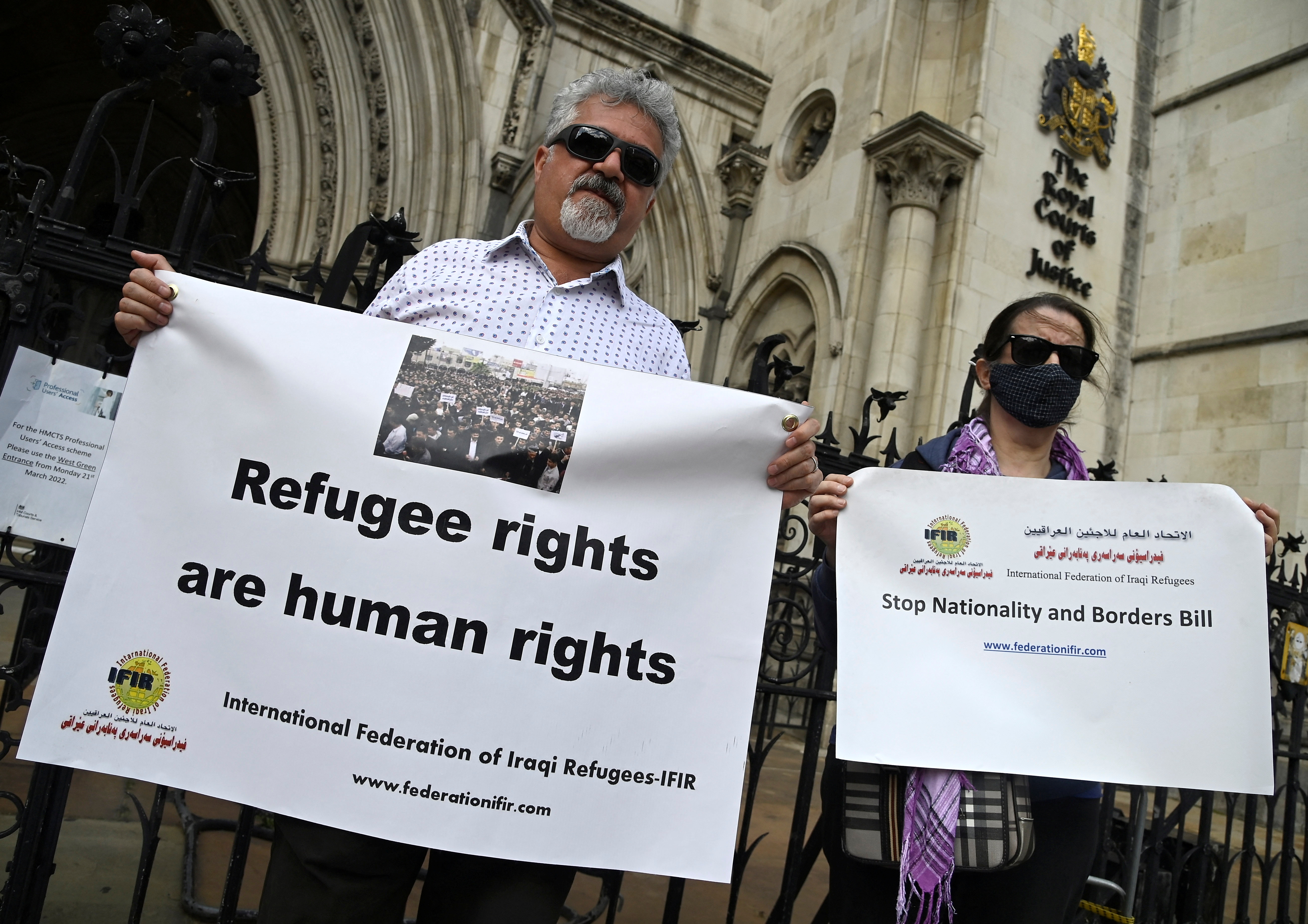 Demonstrators protest outside the Royal Courts of Justice, whilst a legal case is heard over halting a planned deportation of asylum seekers from Britain to Rwanda, London, Britain on June 10, 2022 [Toby Melville/Reuters]